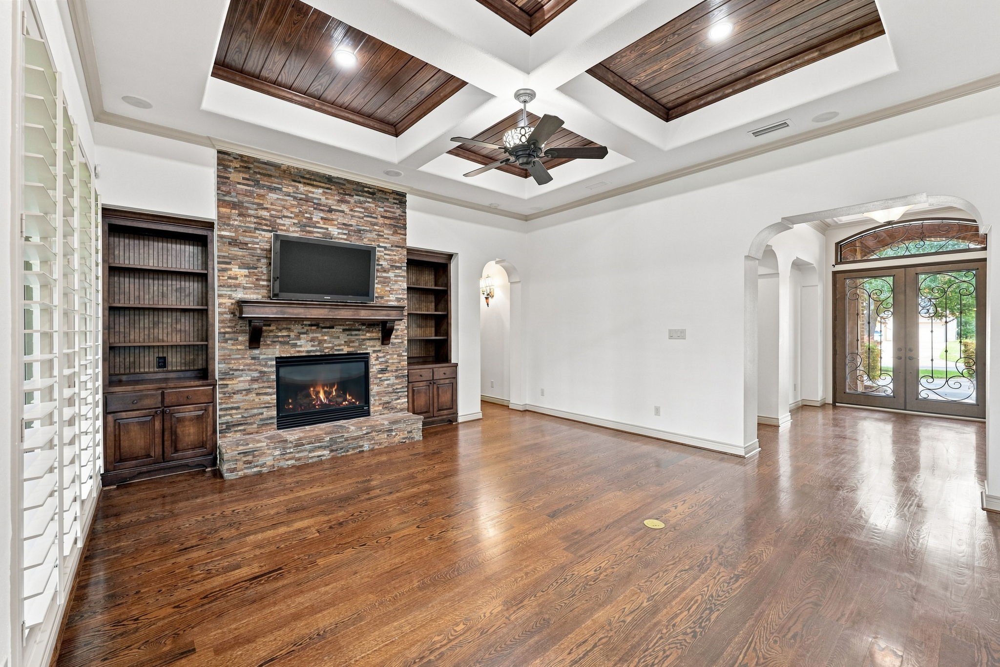 This view from the opposite side of the Family Room looks back toward the Foyer, offering a better perspective of the rooms impressive scale, architectural details, and seamless connection to the entryway. The open, thoughtfully designed layout creates an inviting flow throughout the main living spaces.