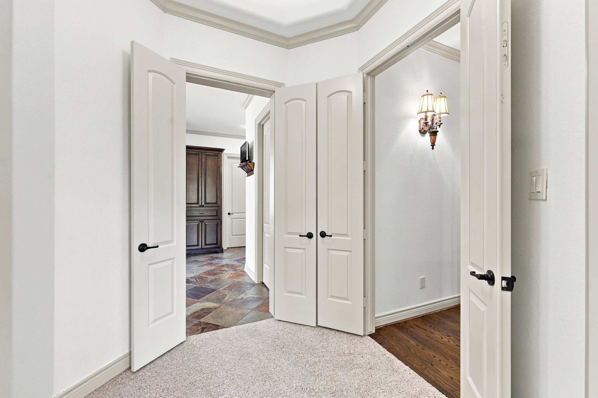 This view showcases the grand entrance to the luxurious Primary Suite, creating an elegant transition from the main living areas into this private retreat. The impressive entry adds a sense of distinction and grandeur to the homes thoughtfully designed floor plan.