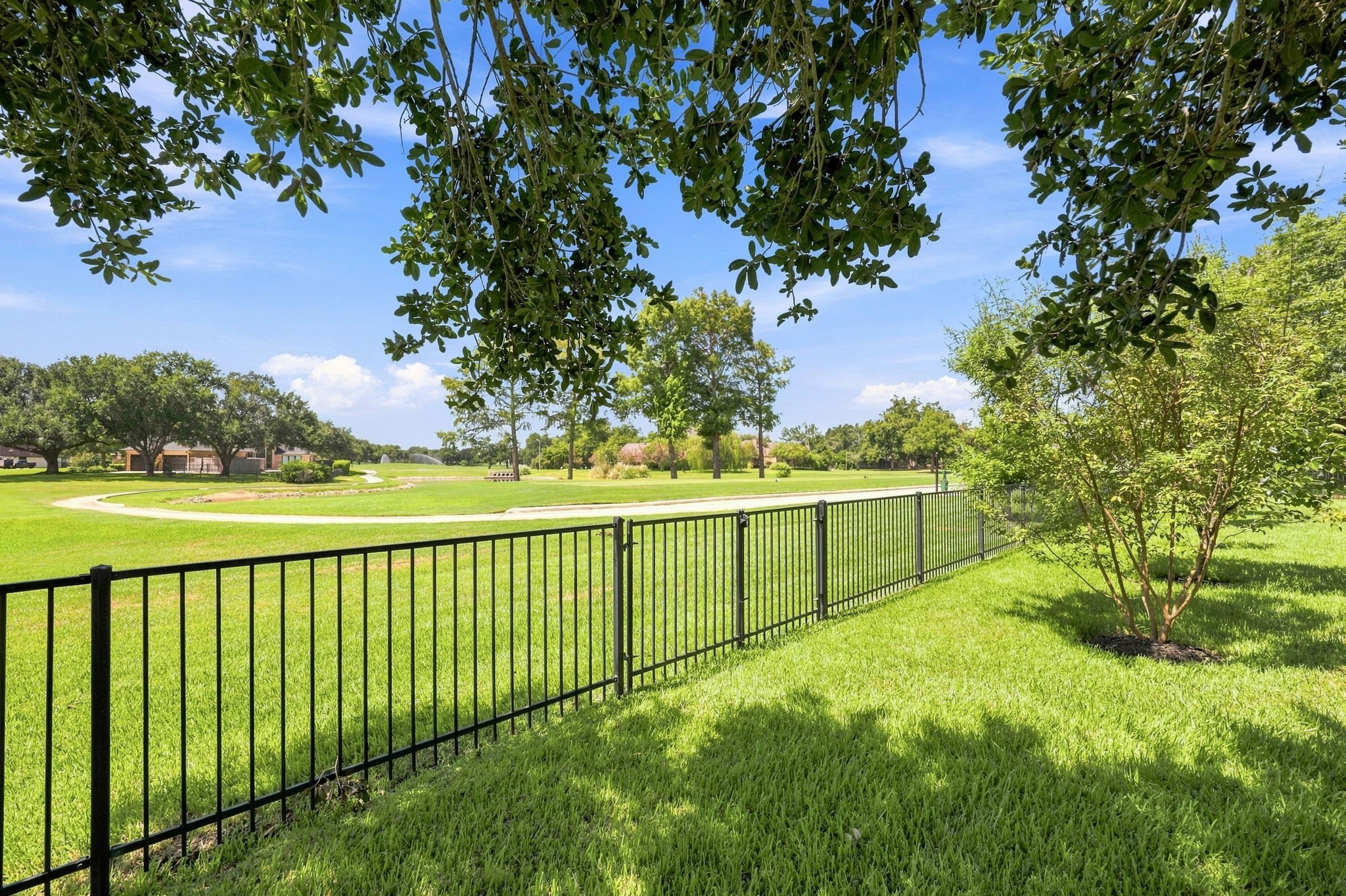 This gorgeous view looks directly toward the 2nd tee box of the golf course, showcasing the homes exceptional location and beautiful golf course backdrop. The peaceful setting and open views create a picturesque atmosphere to enjoy from the property.