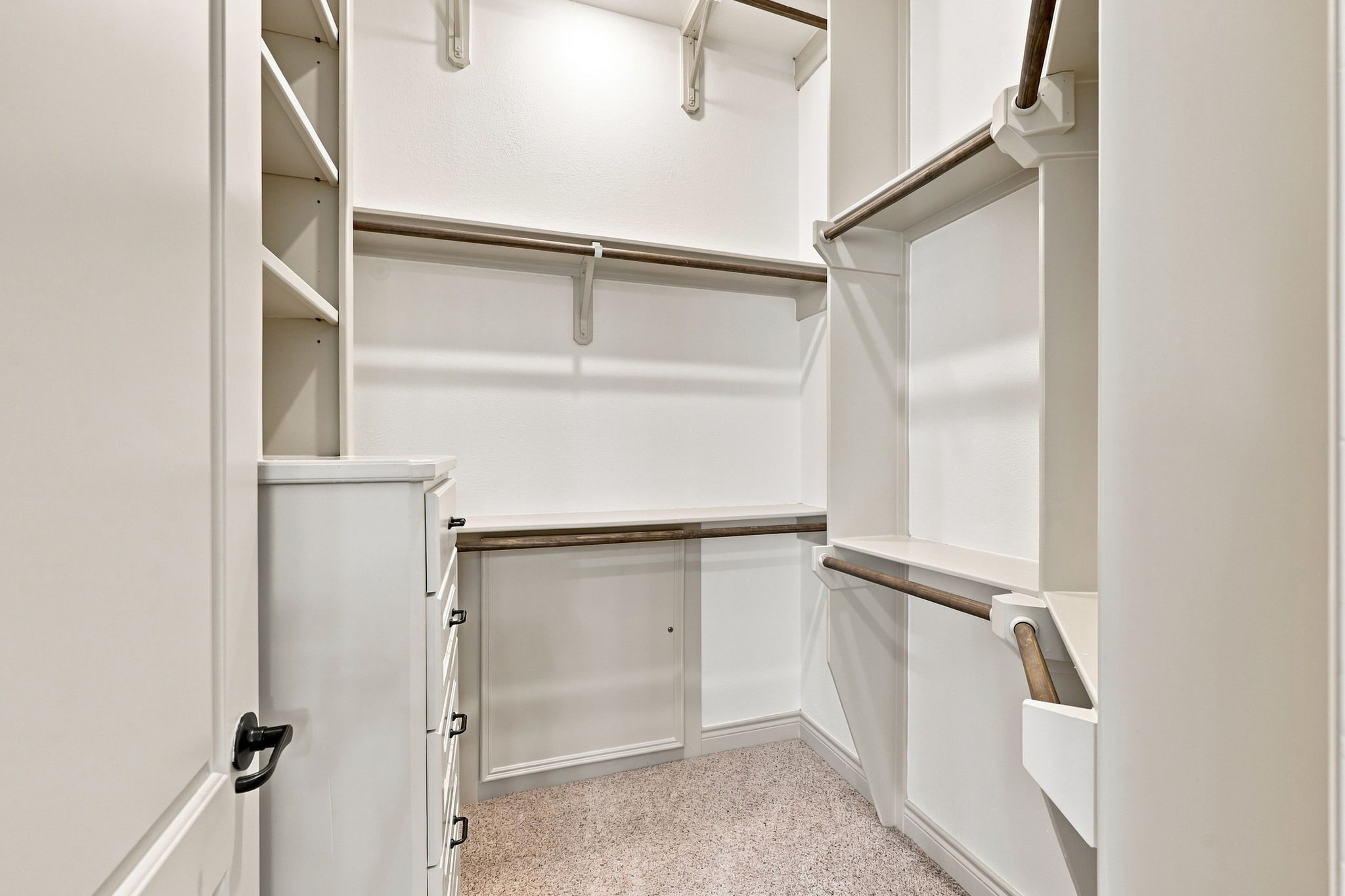 The second closet offers additional storage and organization, featuring a built-in chest of drawers for convenient storage of clothing and personal items. The thoughtful built-in design maximizes functionality while maintaining a clean, polished appearance.