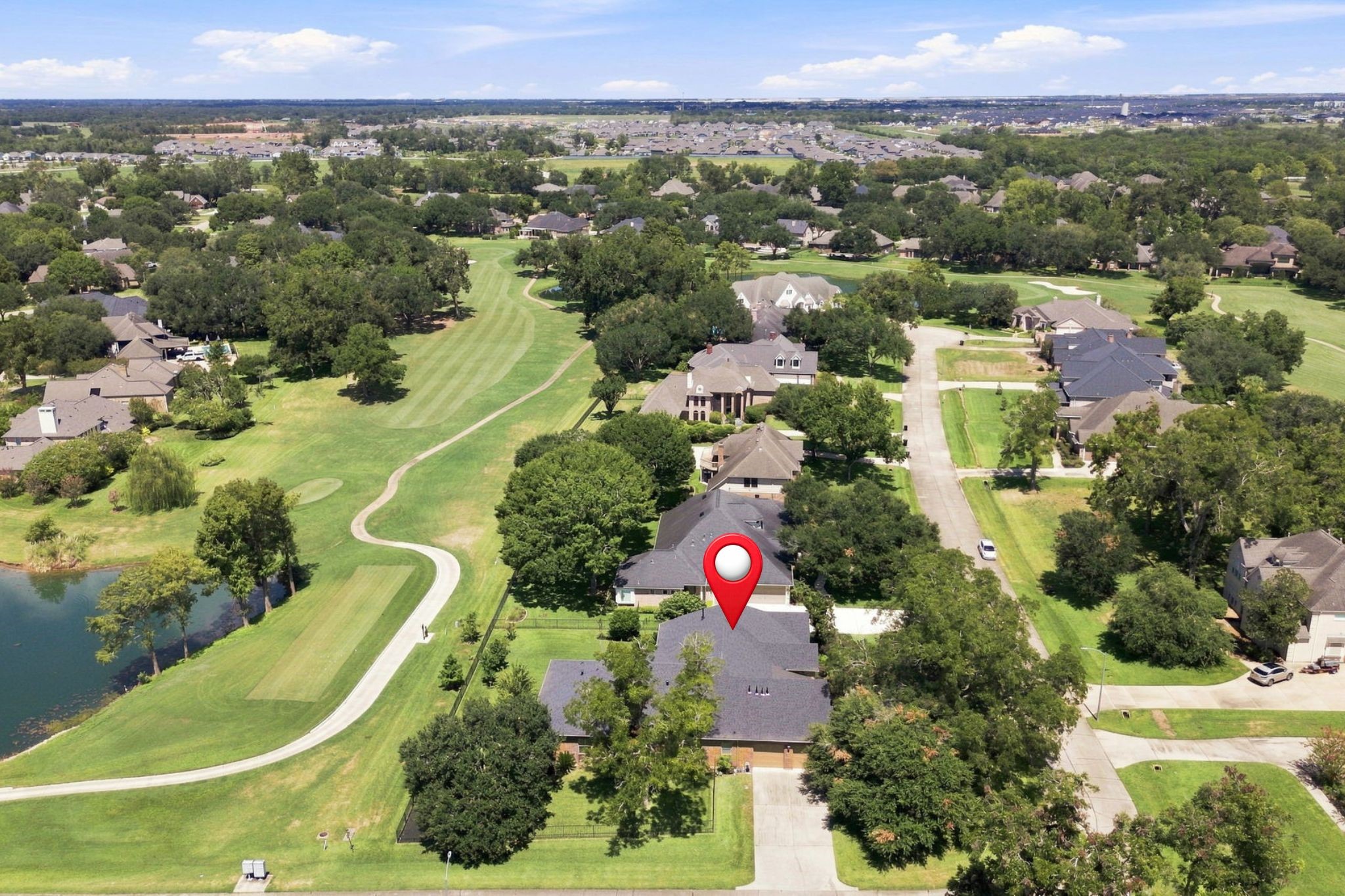 This beautiful view looks north down the 2nd fairway, showcasing the picturesque golf course setting and the expansive views enjoyed from the property.