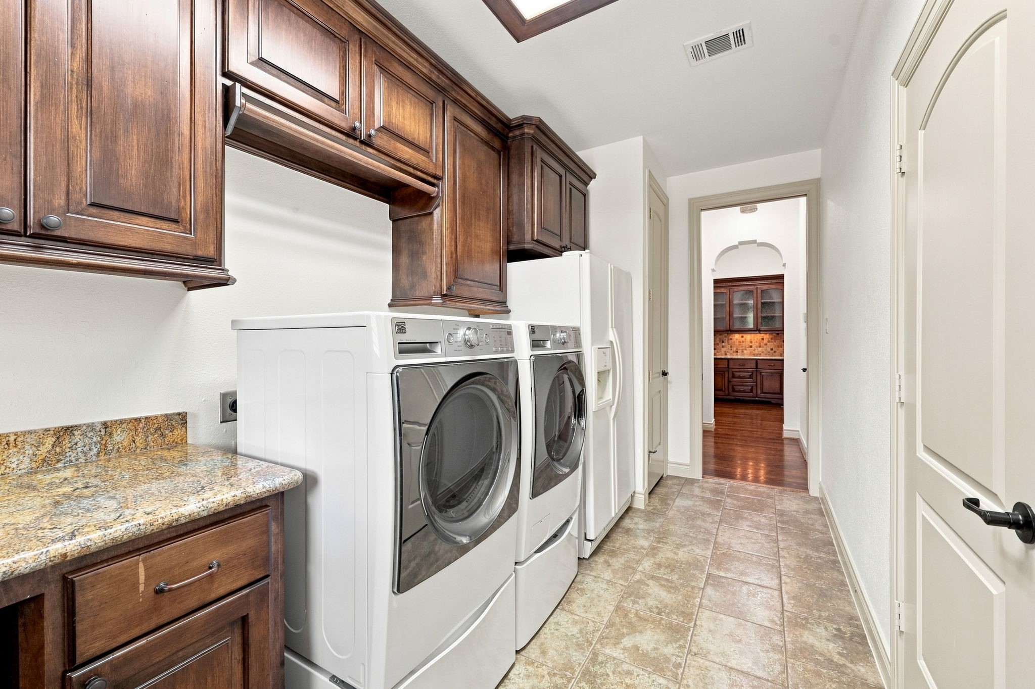 The Laundry Room also includes a washer and dryer, along with a second refrigerator, all of which will remain with the home. Two additional storage closets provide even more convenient space for household essentials, linens, and supplies.