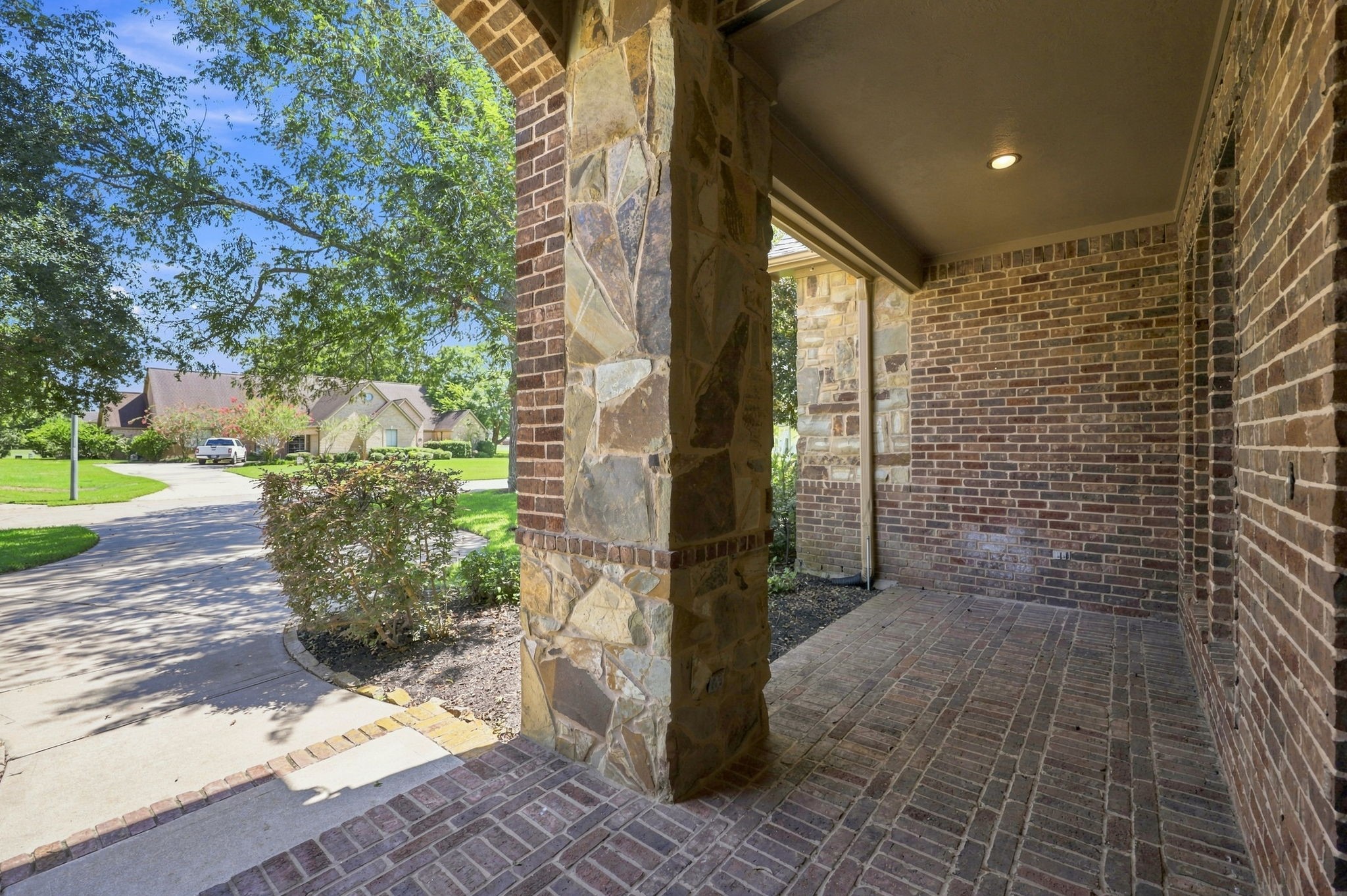As guests make their way to the front entrance, they are welcomed by an expansive covered front porch featuring beautiful brick flooring and impressive stone and brick columns. This inviting entry creates a grand first impression while complementing the homes distinctive architectural design. As guests make their way to the front entrance, they are welcomed by an expansive covered front porch featuring beautiful brick flooring and impressive stone and brick columns. This inviting entry creates a grand first impression while complementing the homes distinctive architectural design.