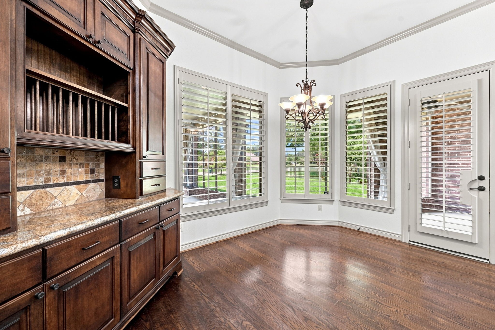 The inviting Breakfast area is the perfect spot to start your day, surrounded by an abundance of windows that fill the space with beautiful natural light. Direct access to the screened-in back patio creates a seamless connection to the outdoors and provides a wonderful setting for morning coffee, casual meals, and relaxed gatherings.