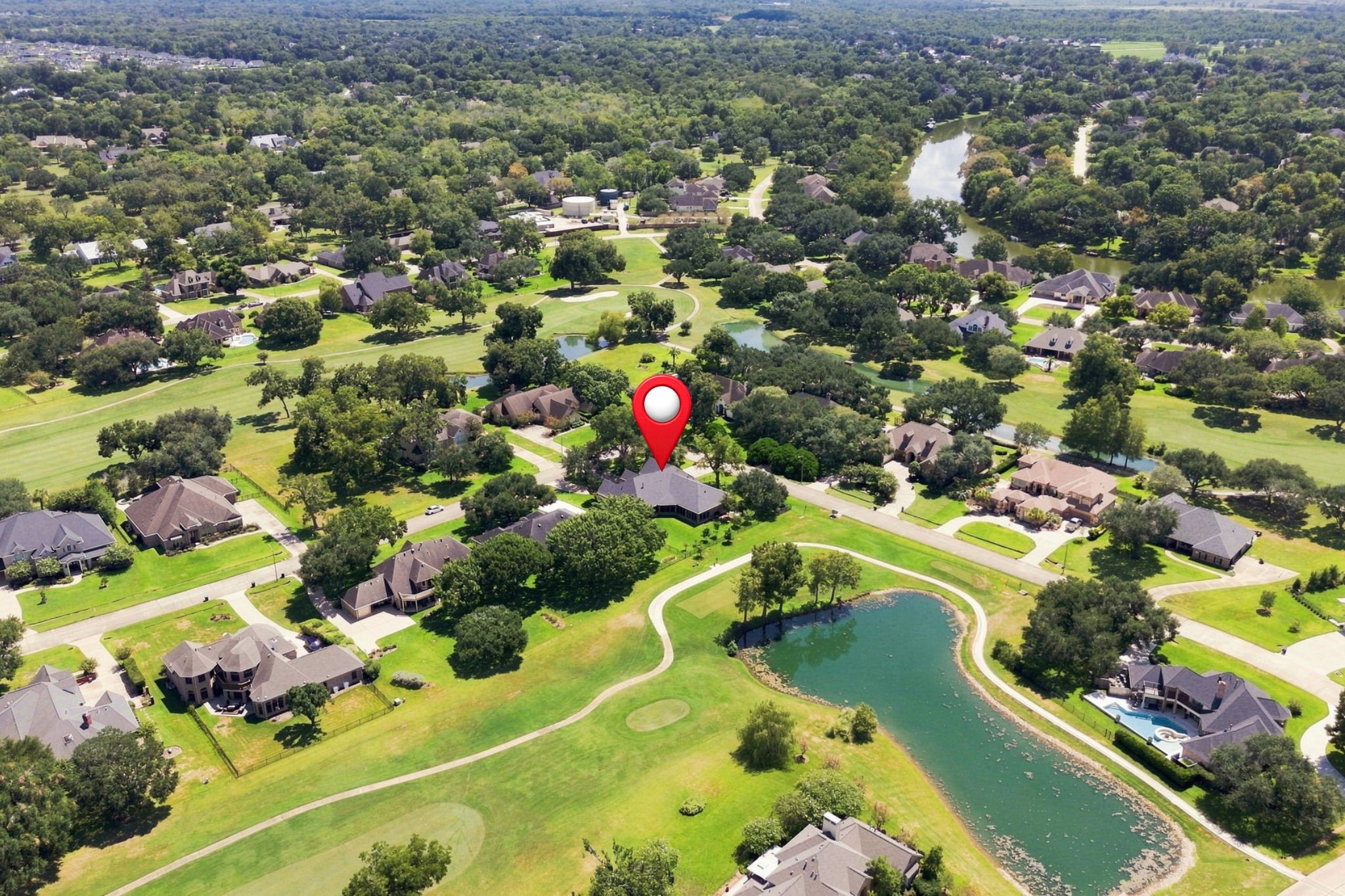 This view looks south across the surrounding area and shows the golf course meandering through the neighborhood.