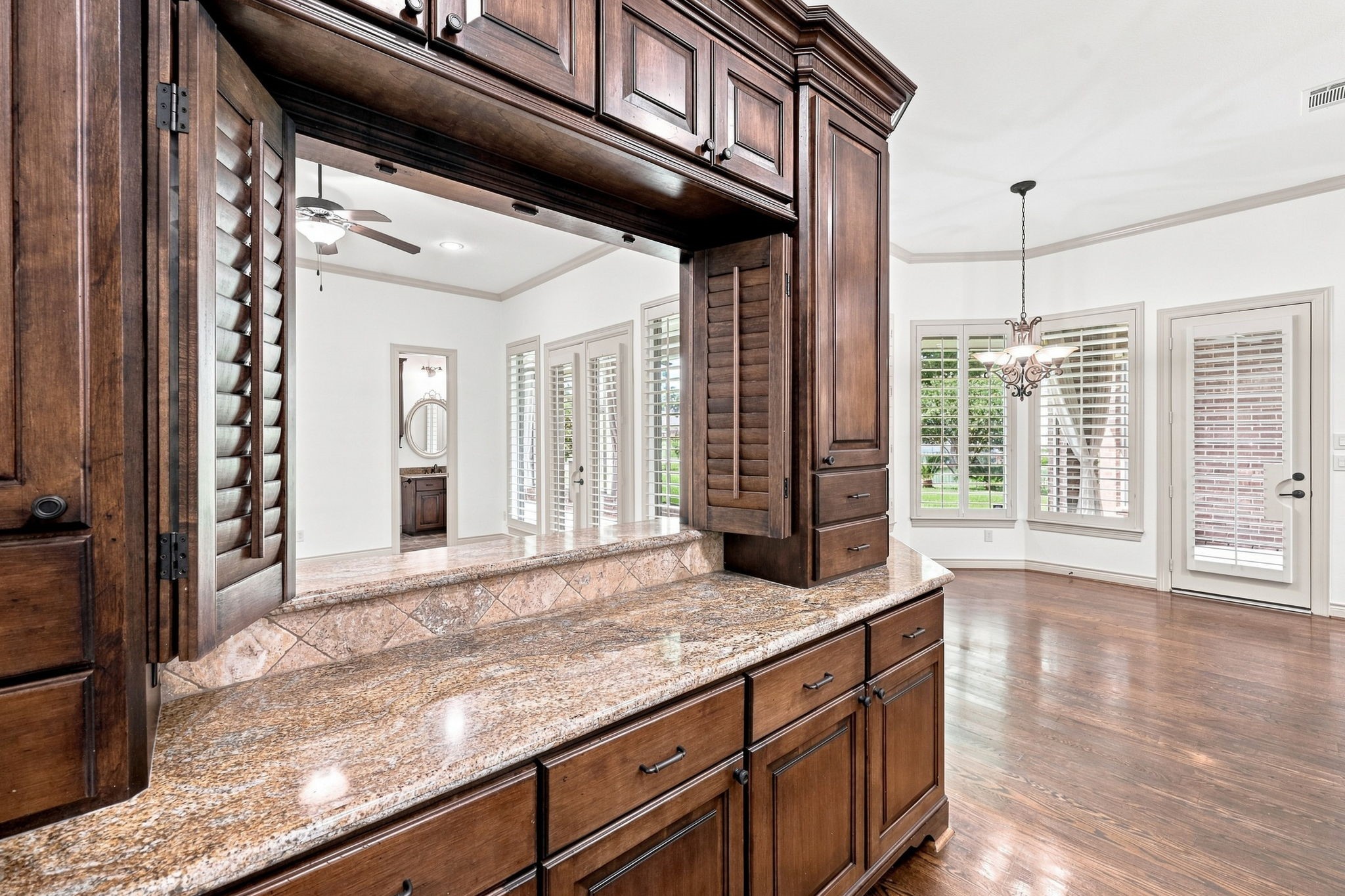 Additional custom cabinetry and a convenient serving area provide exceptional functionality, with direct access to the Game Room for effortless serving and entertaining. This thoughtful design makes it easy to transition from the Kitchen to the Game Room when hosting family and guests.