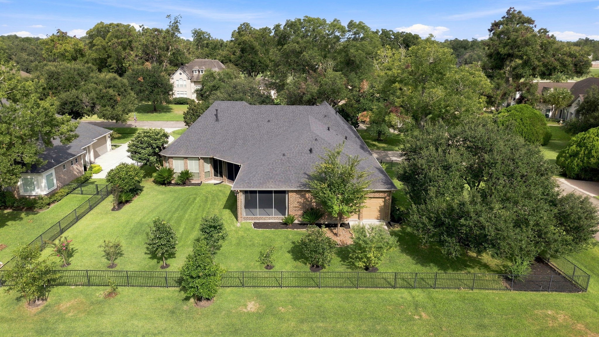 A closer look at the spacious backyard showcases the generous outdoor space, mature landscaping, and peaceful golf course setting beyond. With plenty of room for a pool and additional outdoor living, this backyard offers endless possibilities for creating your own private retreat.