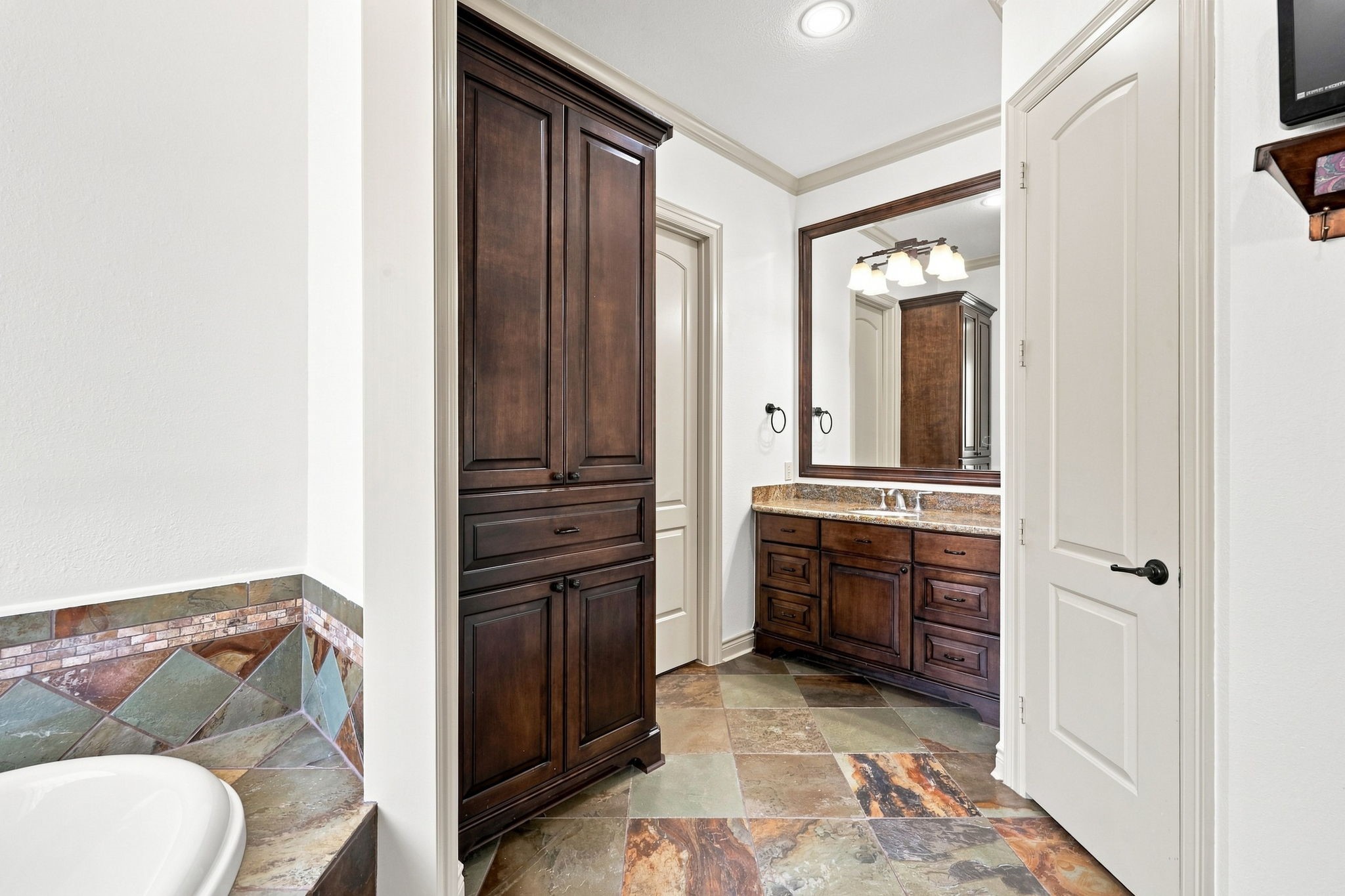 This second vanity area features beautiful custom cabinetry and abundant additional storage, providing both elegance and functionality.