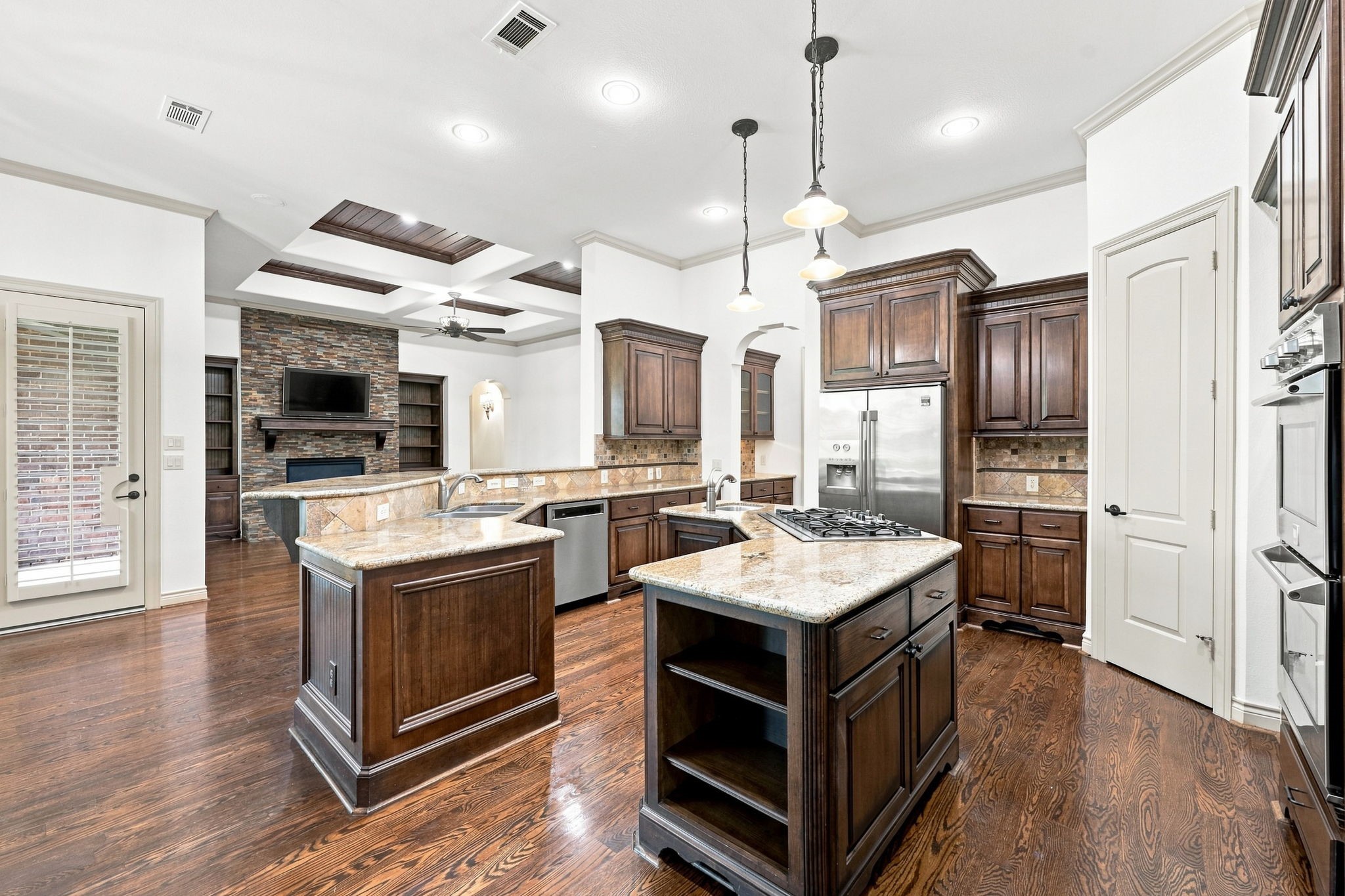 The spacious Kitchen Island offers abundant storage, a convenient second sink for food preparation, and generous counter space for serving, gathering, and entertaining. Three stylish pendant lights overhead add an elegant finishing touch while providing beautiful illumination to this impressive centerpiece of the Kitchen.