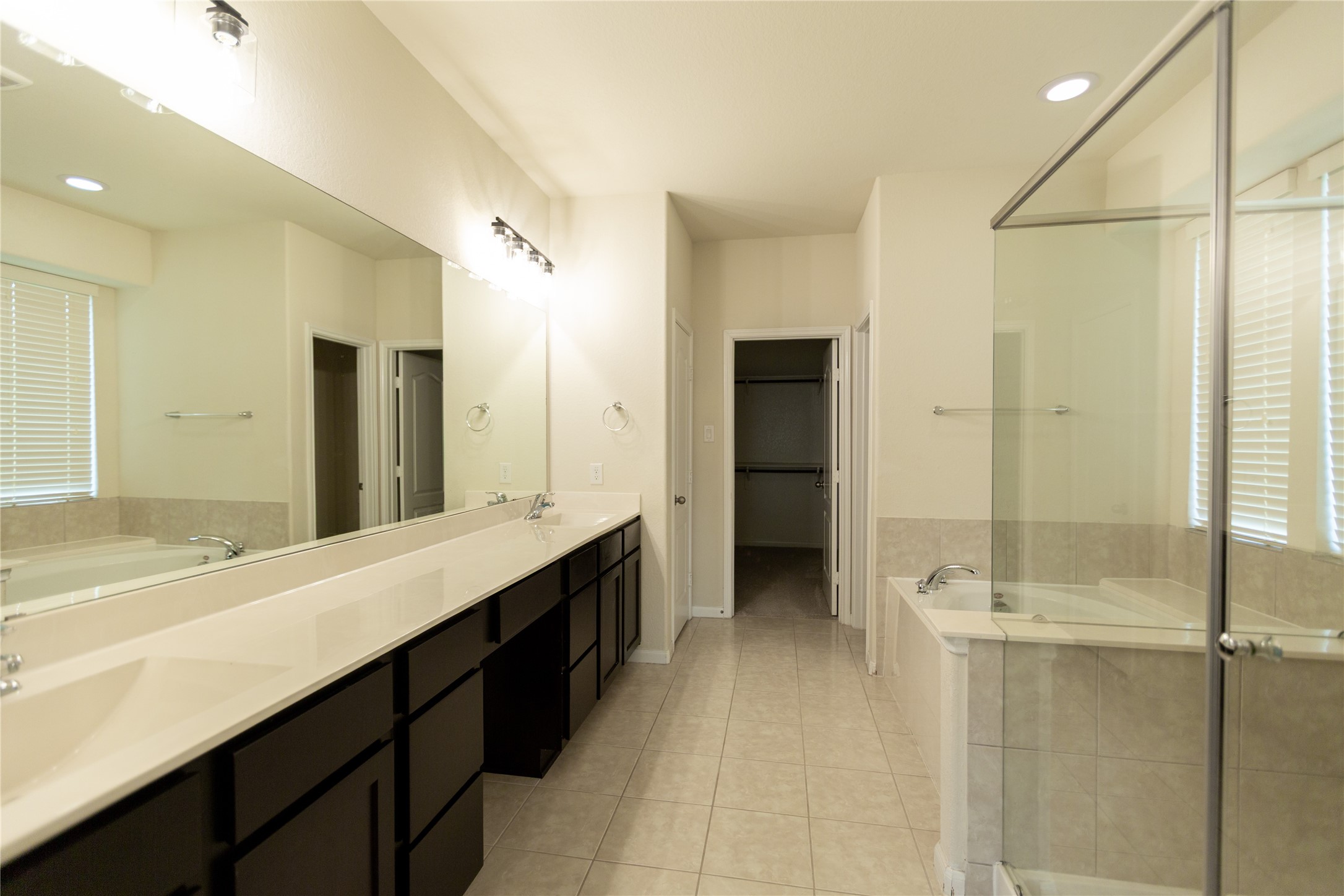 Primary Bathroom with double sinks and extended shower space