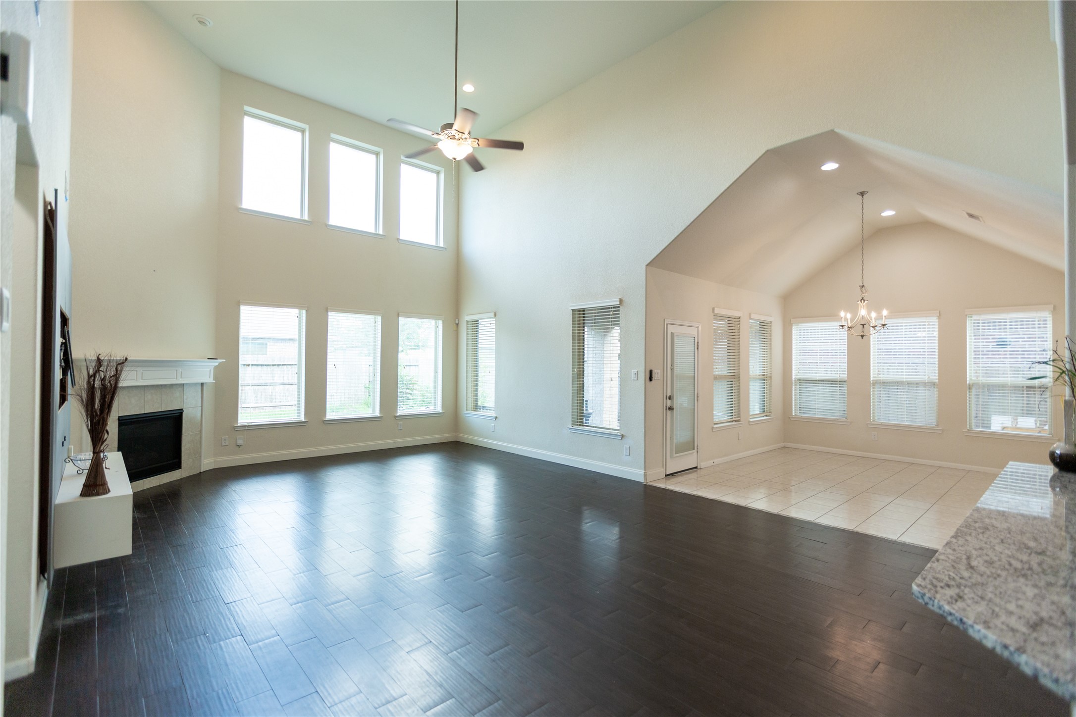 Open living room with high ceilings connected to breakfast area