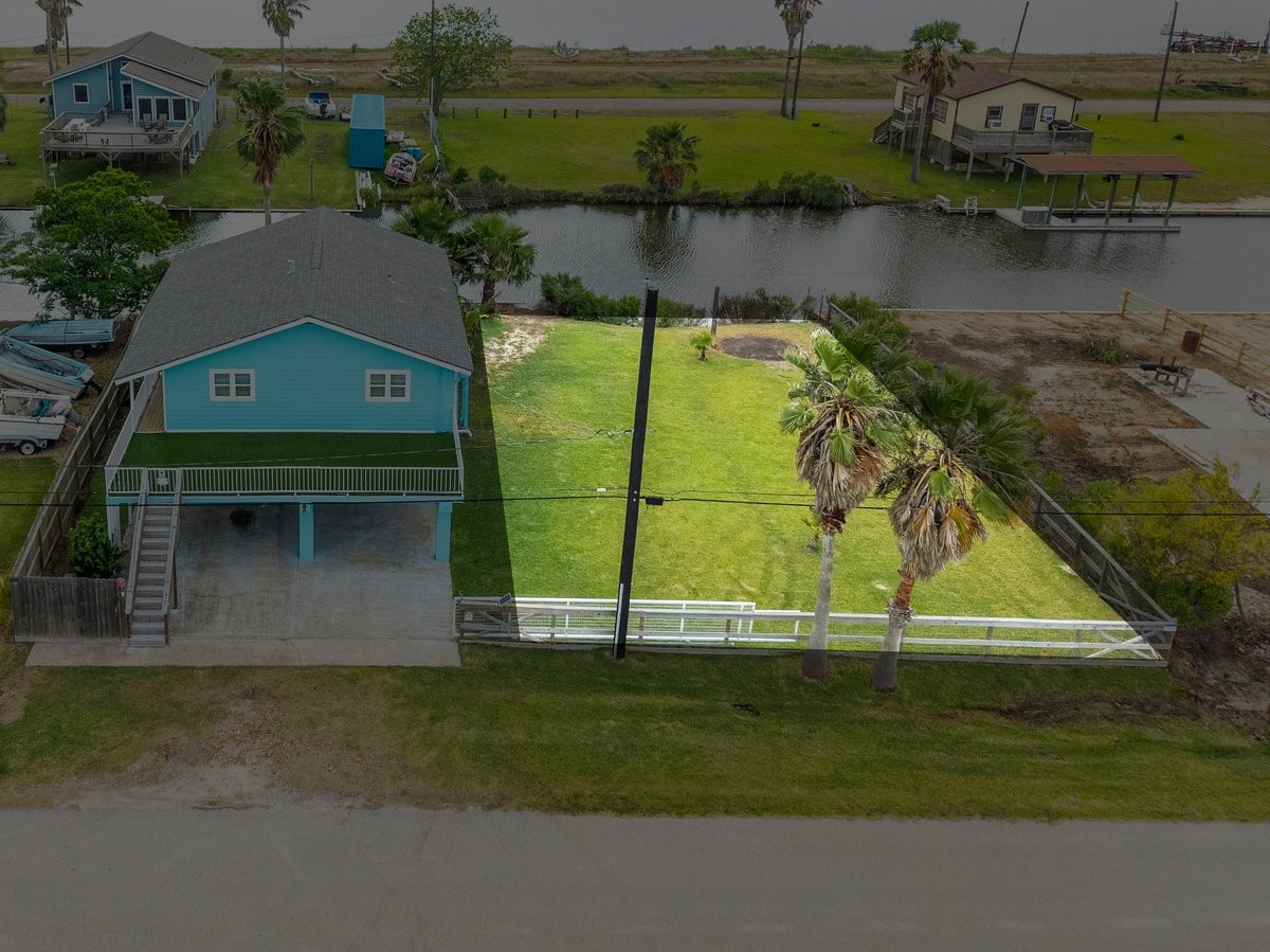 House is sold with an extra lot. The lot is plated & taxed separately from the house.