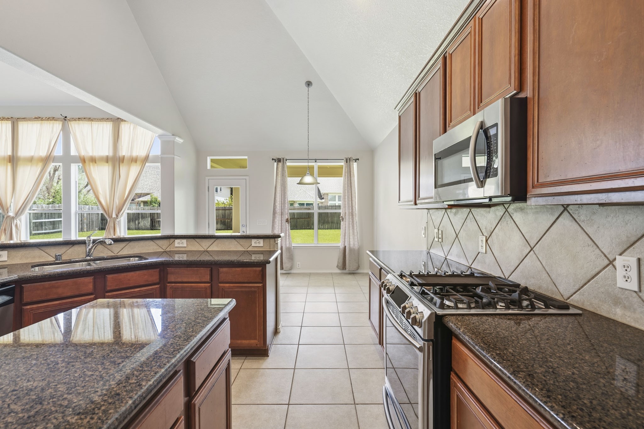Additional view highlighting the kitchen's spacious design, abundant workspace, and easy flow into the home's main living areas.