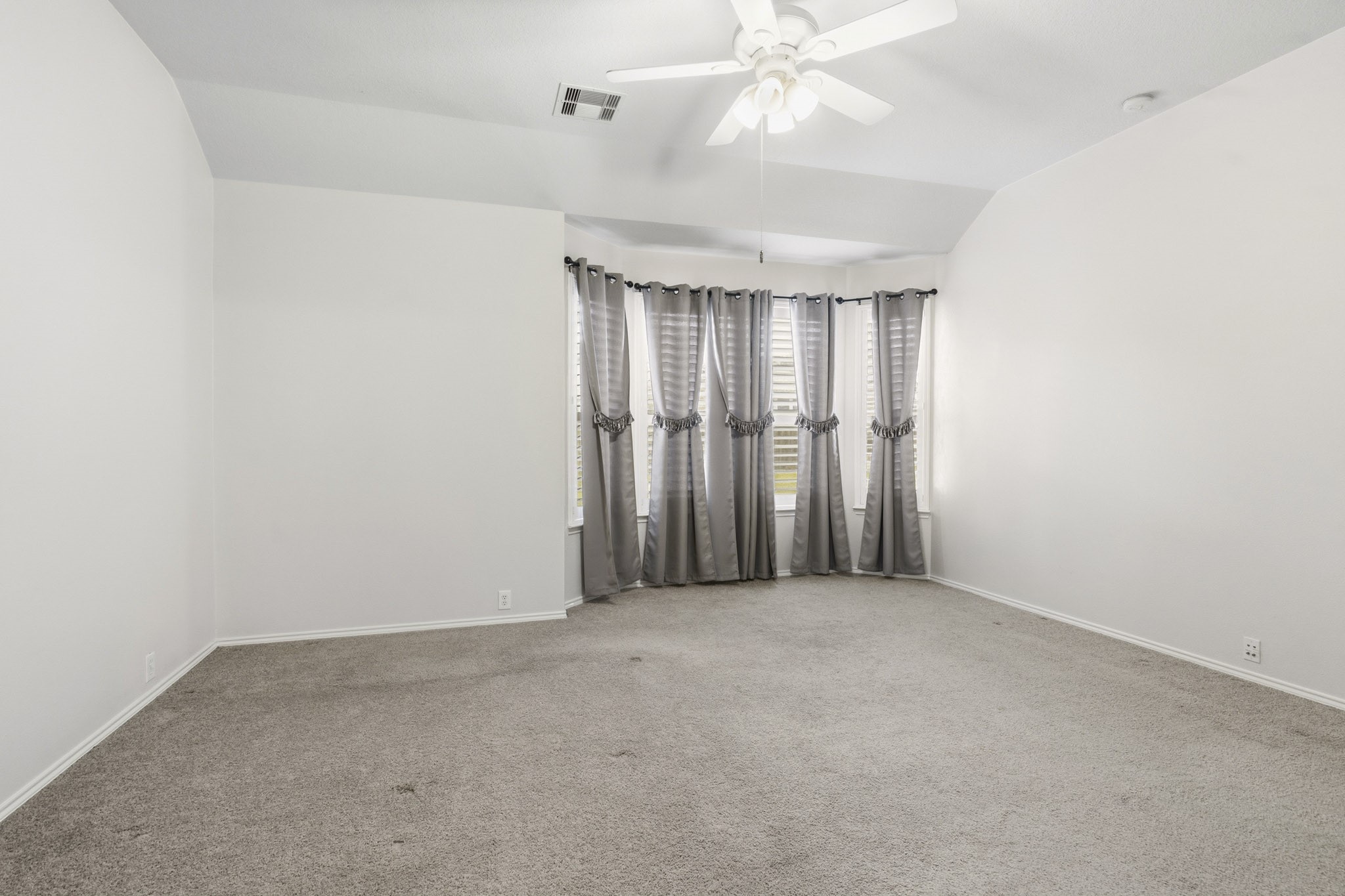 Relaxing primary suite featuring plantation shutters, generous dimensions, and a peaceful retreat at the end of the day.