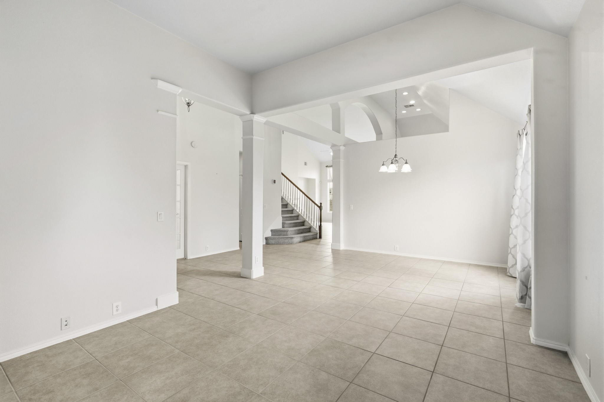 Another view of the formal living and dining areas, highlighting the home's spacious layout and versatile entertaining spaces.