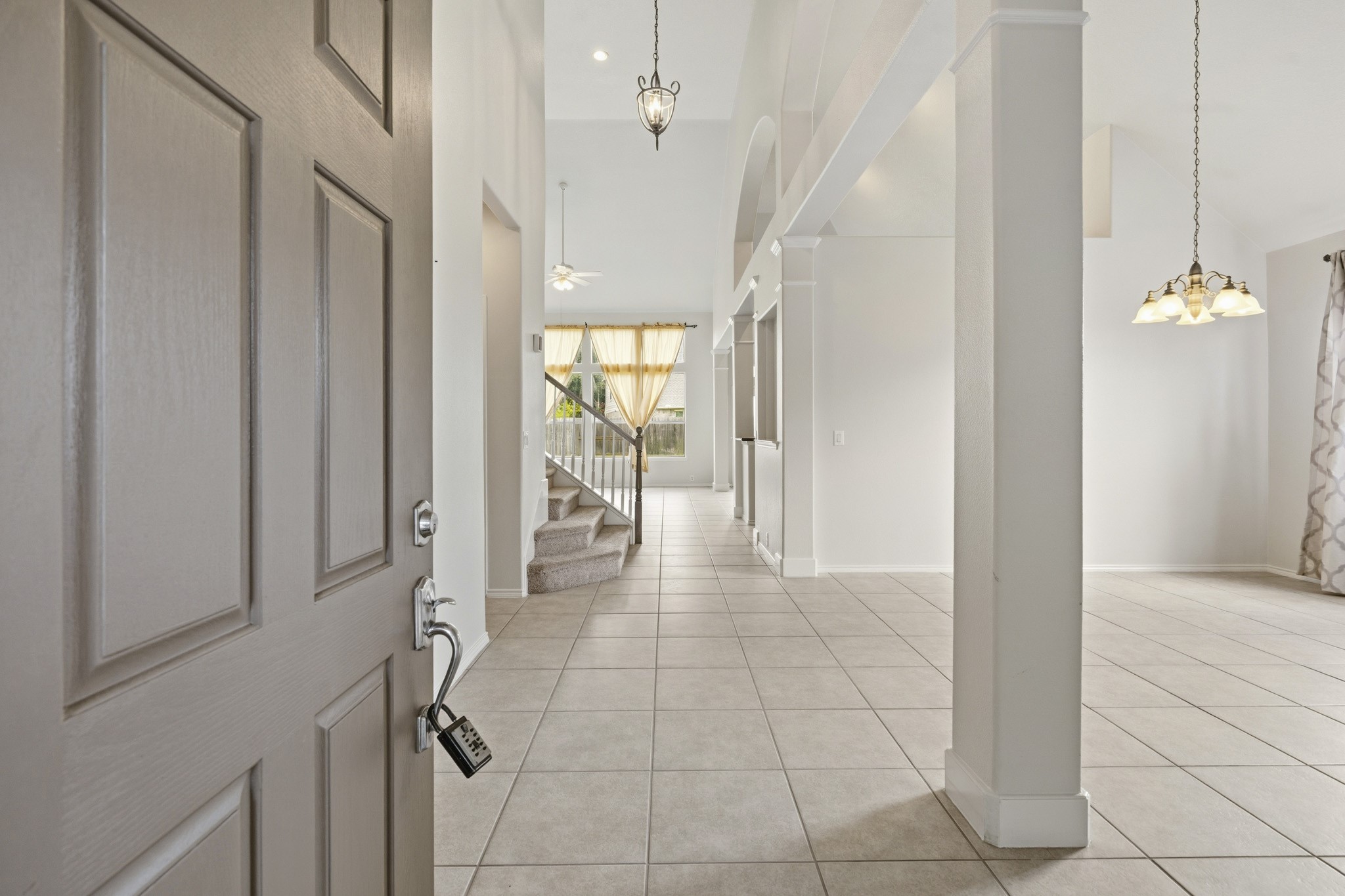 Elegant tiled entryway offering a warm welcome and beautiful sightlines into the formal living and dining areas.