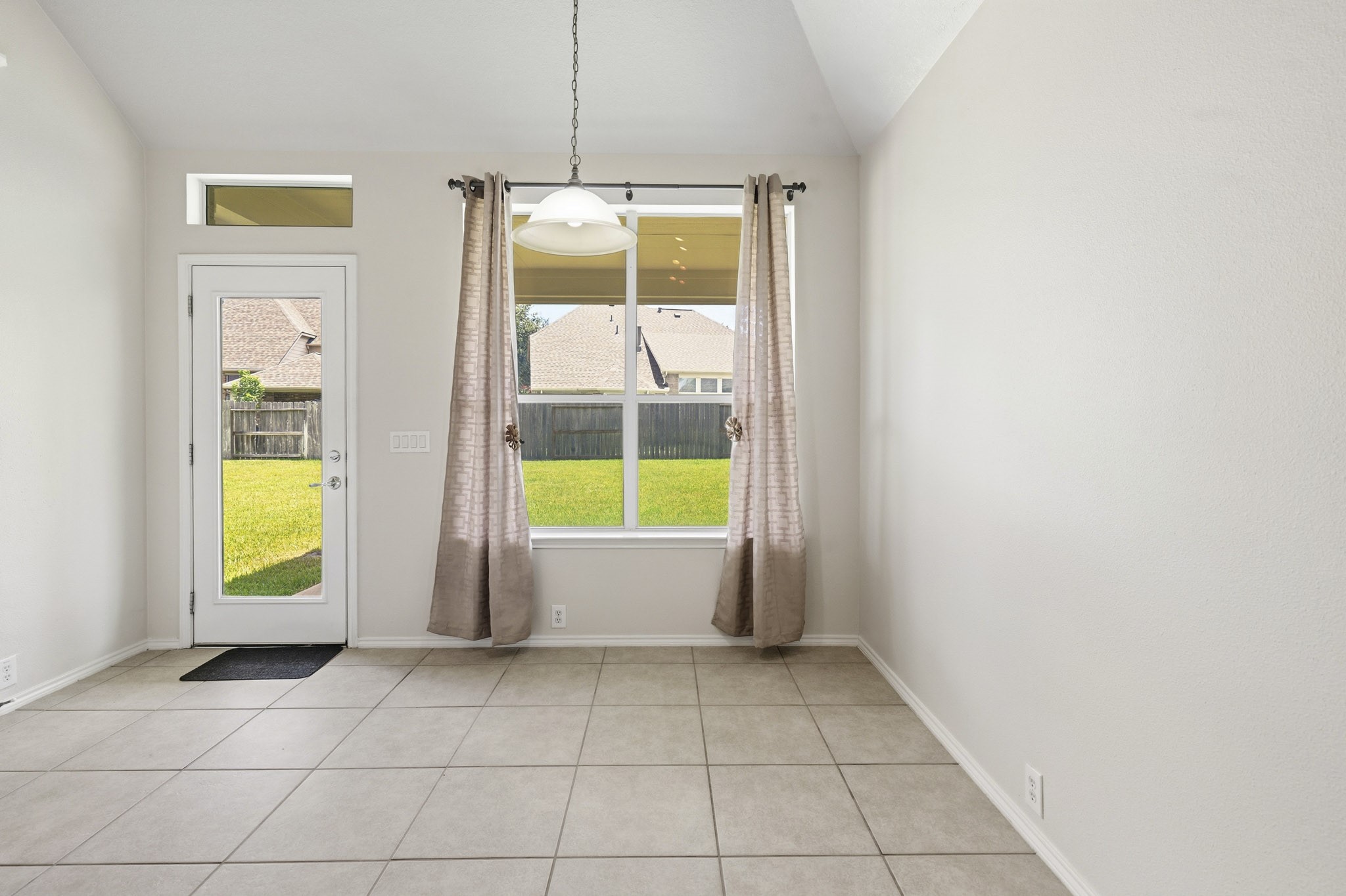 Breakfast area and rear access leading to the covered patio, creating an ideal space for outdoor grilling, dining, and entertaining.
