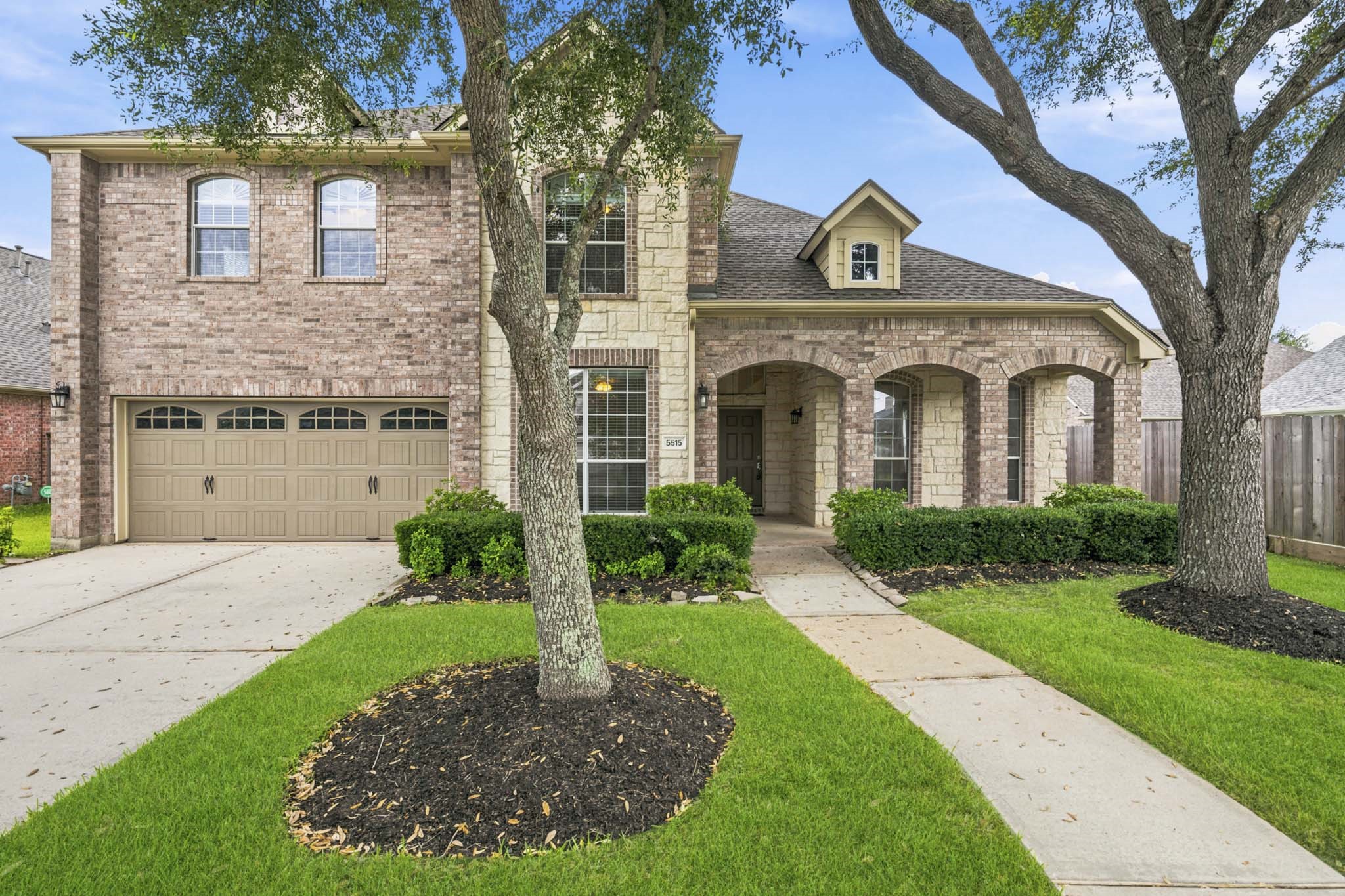 Welcoming front porch with comfortable seating area, framed by an attractive stone-and-brick exterior that creates outstanding curb appeal. Welcoming front porch with comfortable seating area, framed by an attractive stone-and-brick exterior that creates outstanding curb appeal.