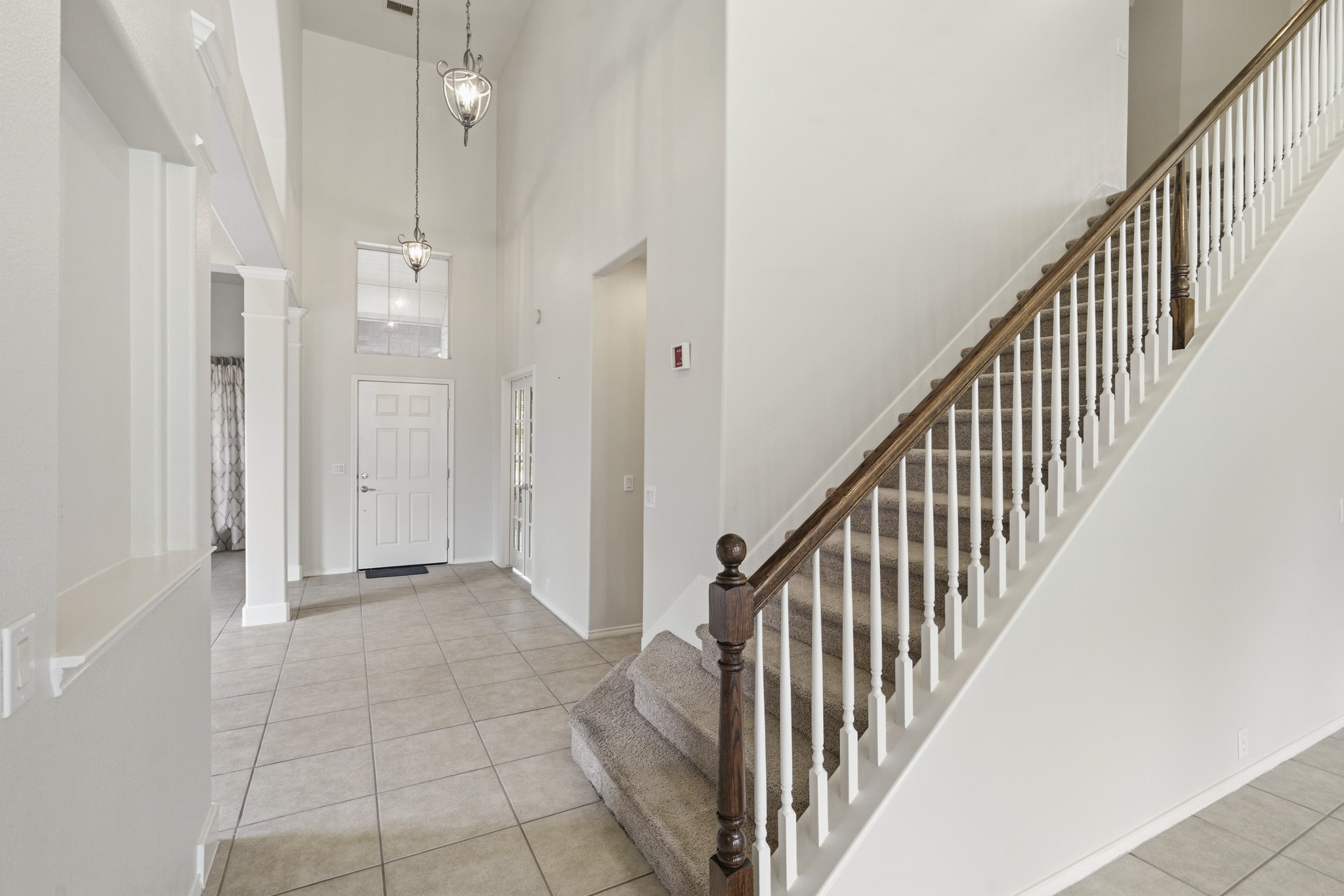 Grand entry featuring French doors leading to a large private study with a walk-in closetideal as a home office or potential fifth bedroomwith convenient access to the powder bath.