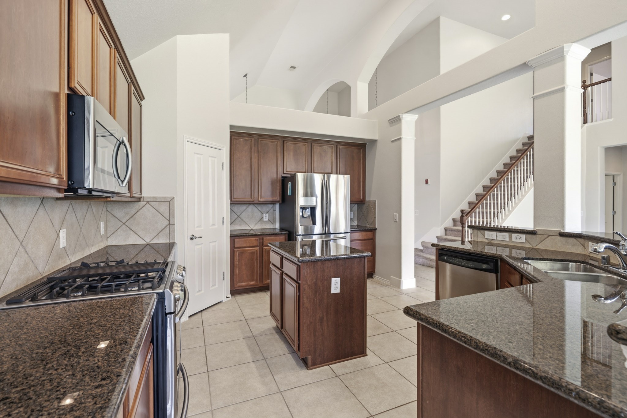Large island kitchen offering abundant cabinetry, generous counter space, and excellent storage for all your culinary needs.