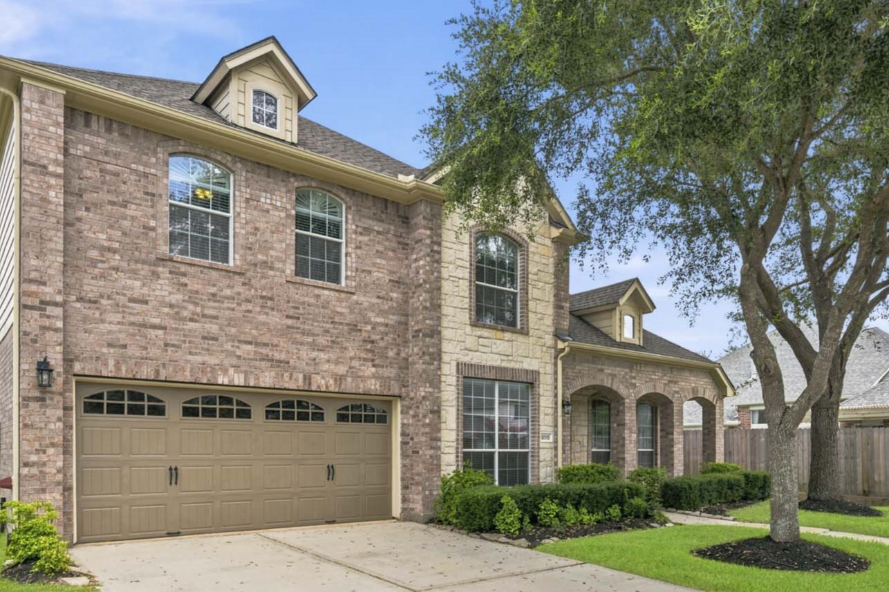 Spacious two-car garage featuring durable epoxy flooring, providing both functionality and a clean, polished appearance.