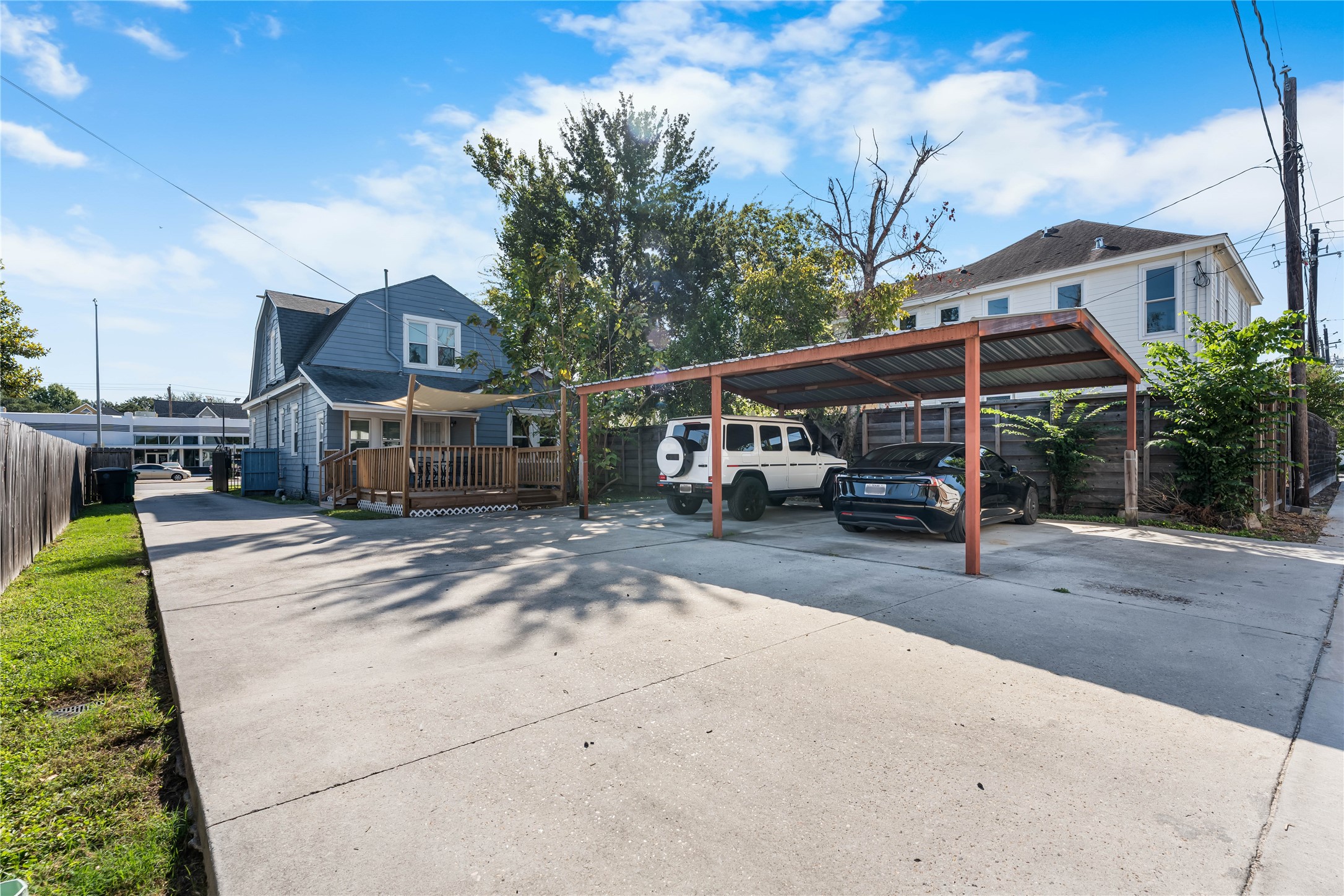 Gated driveway access offers added convenience and separation between the street frontage and rear parking area.