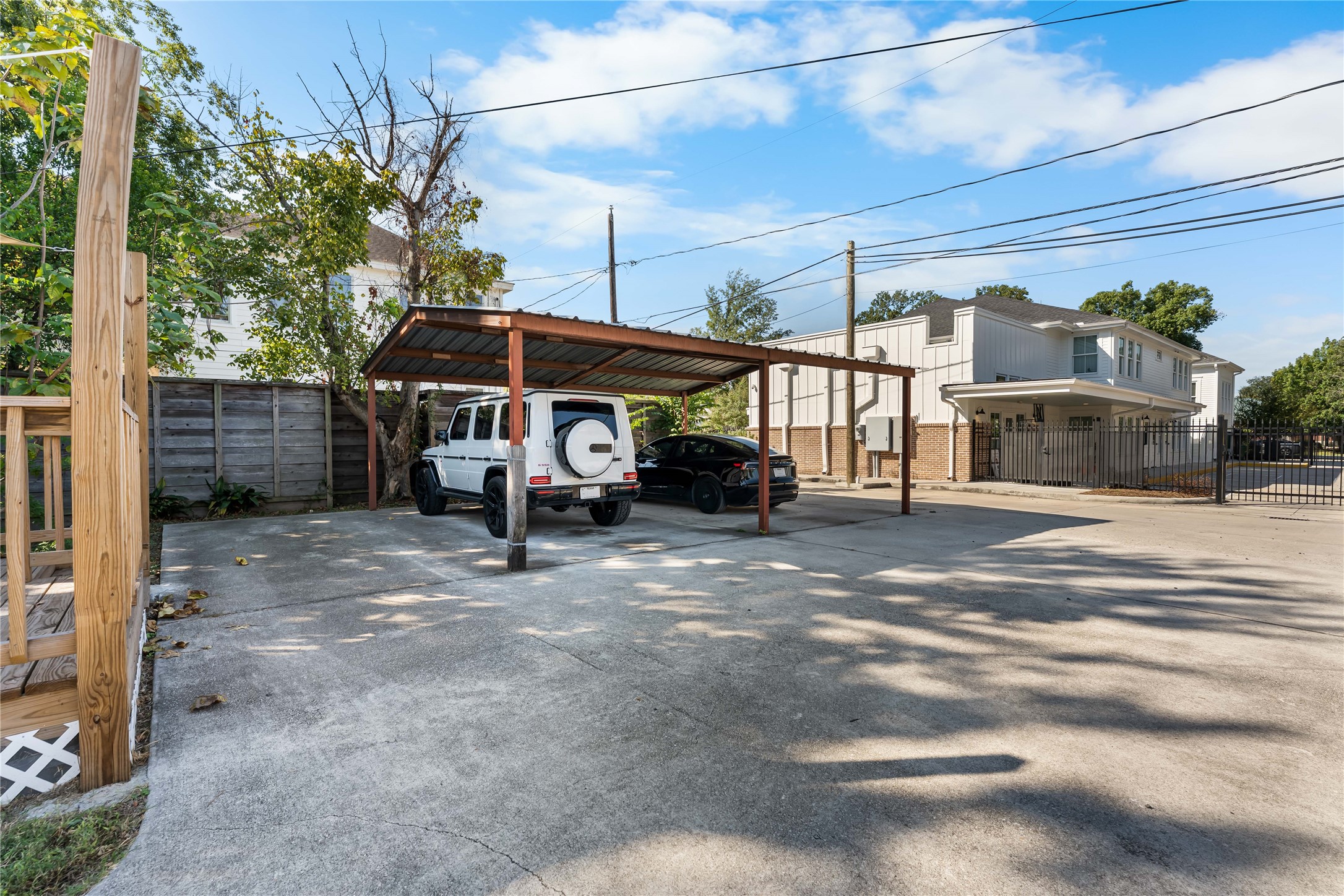 Generous paved parking area with covered spaces.