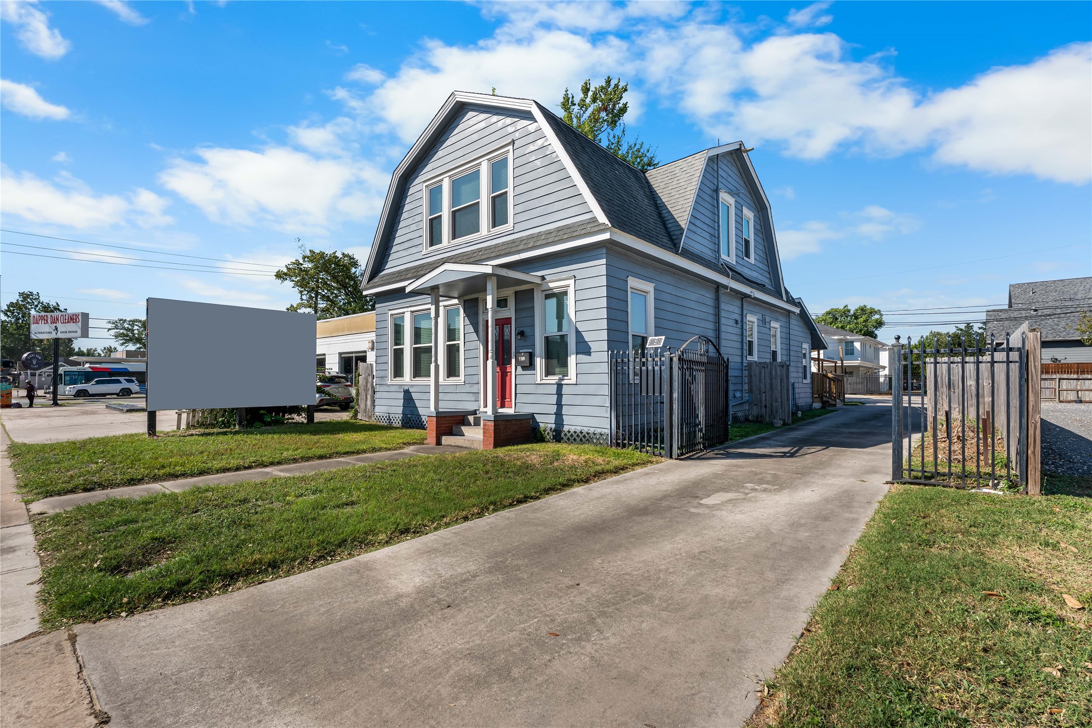 Featuring a private driveway, gated access, and additional parking toward the rear of the property.