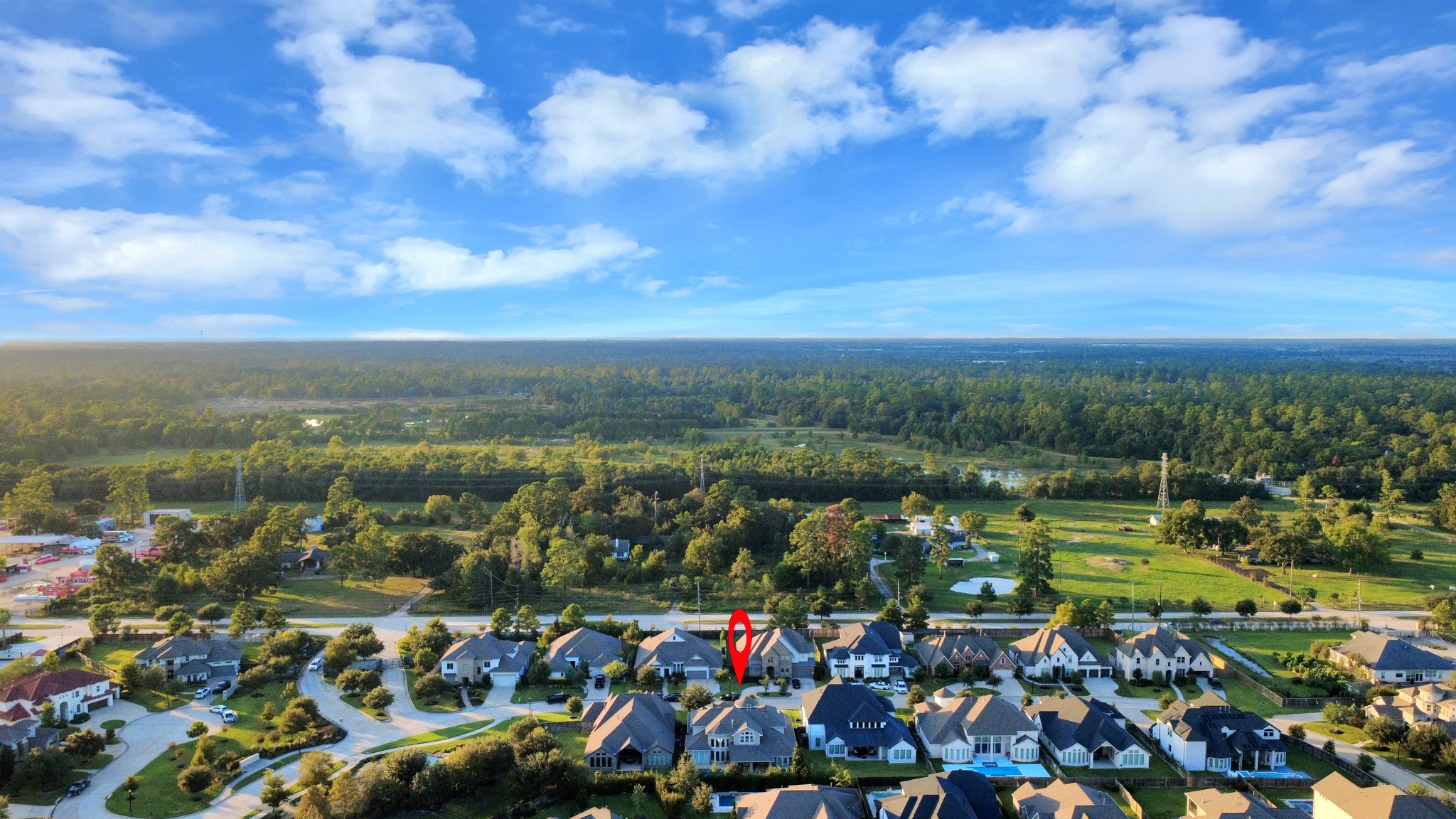 Aerial view highlighting the home's desirable location within the gated Bridlecreek community, surrounded by mature trees, scenic green spaces, and a secluded residential setting with limited surrounding development.