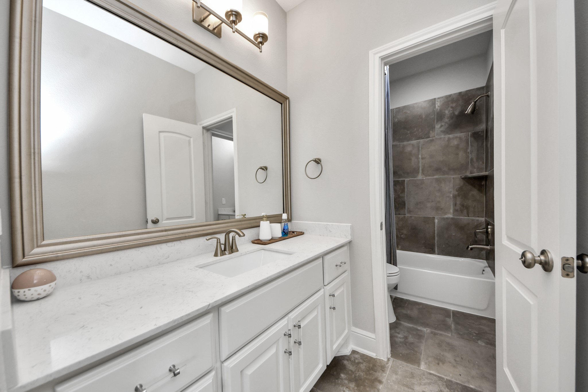 Additional bathroom view showcasing the generous vanity and storage space.
