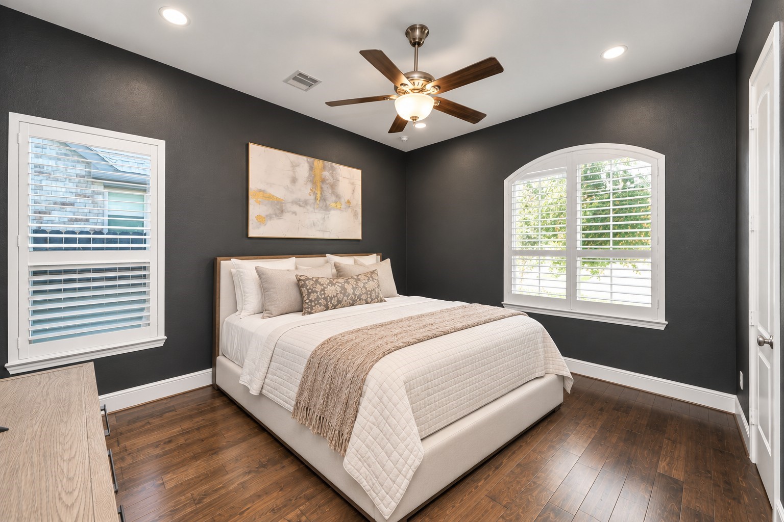 Private 1st floor secondary bedroom located at the front of the home, featuring plantation shutters, a secluded hallway entrance, and its own en-suite bathroom with walk-in shower.