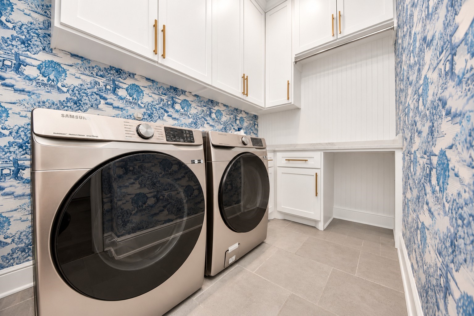 First-floor utility room featuring built-in cabinetry, ample storage, and convenient countertop space.