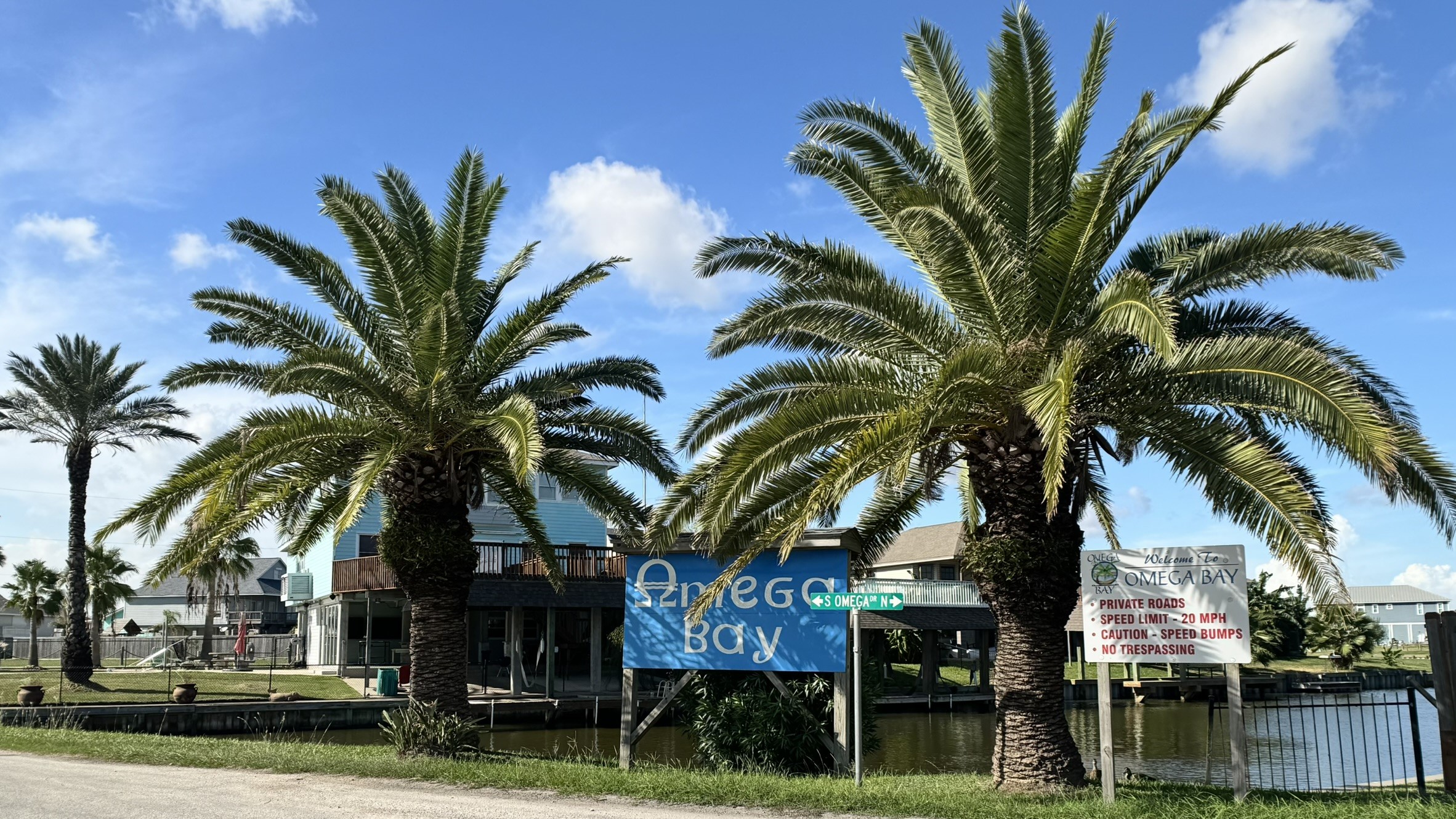 Welcome to Omega Bay, a private waterfront community in La Marque with palm-lined streets, private roads, and canal access just steps from the entrance.