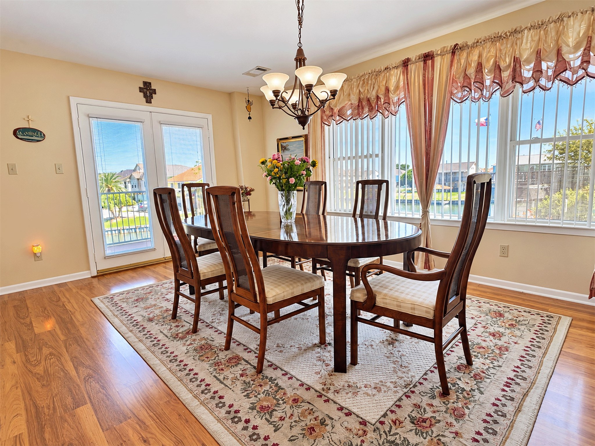 Dining room with French doors leading out to the deck and water views.
