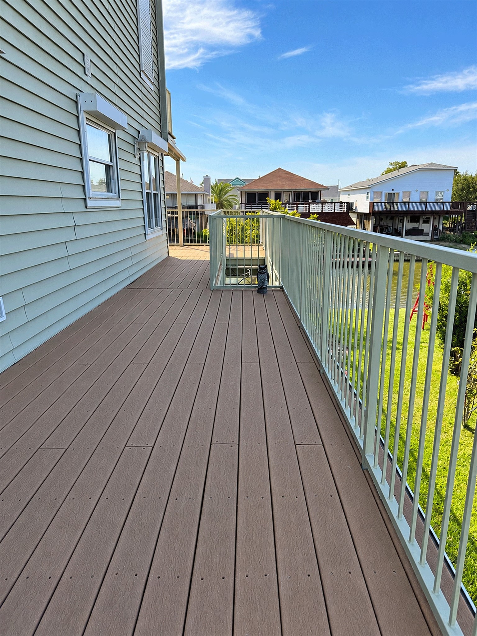 Deck walkway along the side of the home, towards the kitchen entrance.