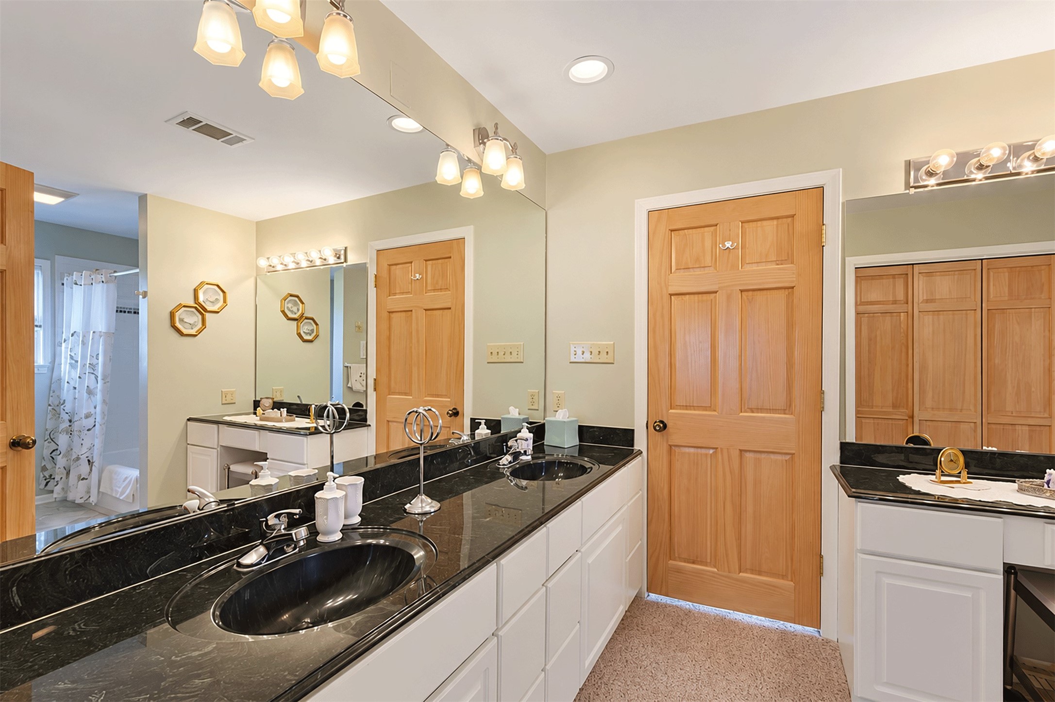 Large Jack and Jill bath with granite counters and separate vanities.
