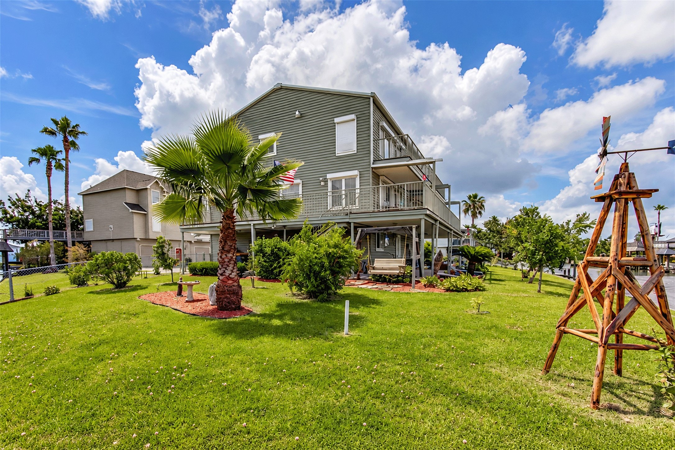 An open yard that creates a relaxed coastal setting. An open yard that creates a relaxed coastal setting.