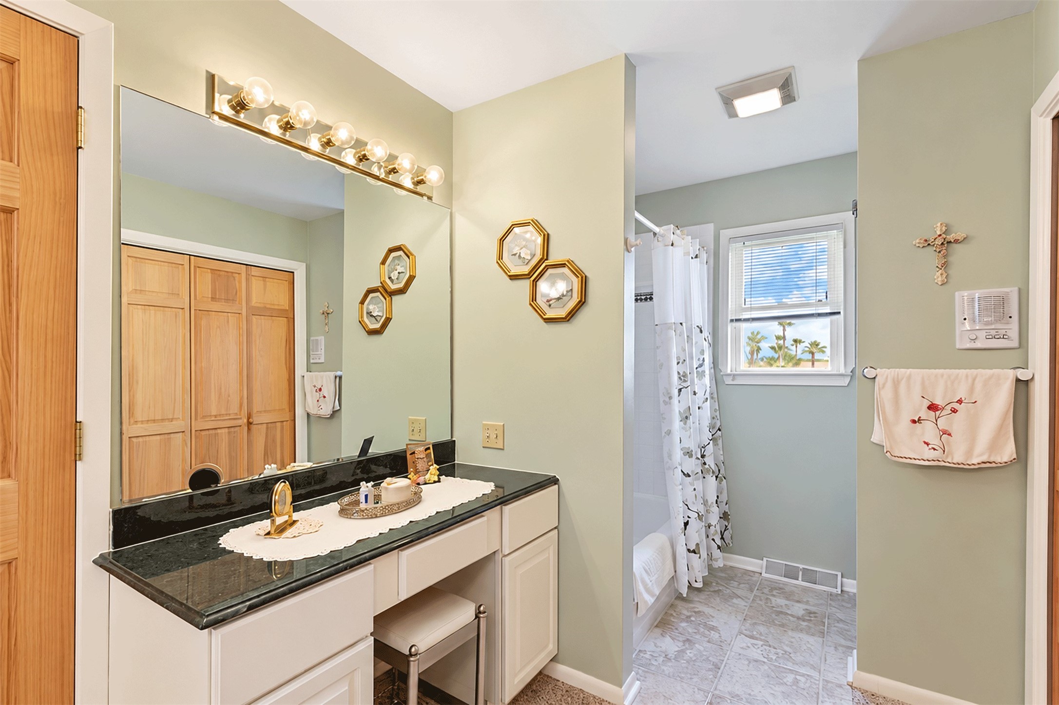 Private vanity area in the same bath, with a tub/shower combo.