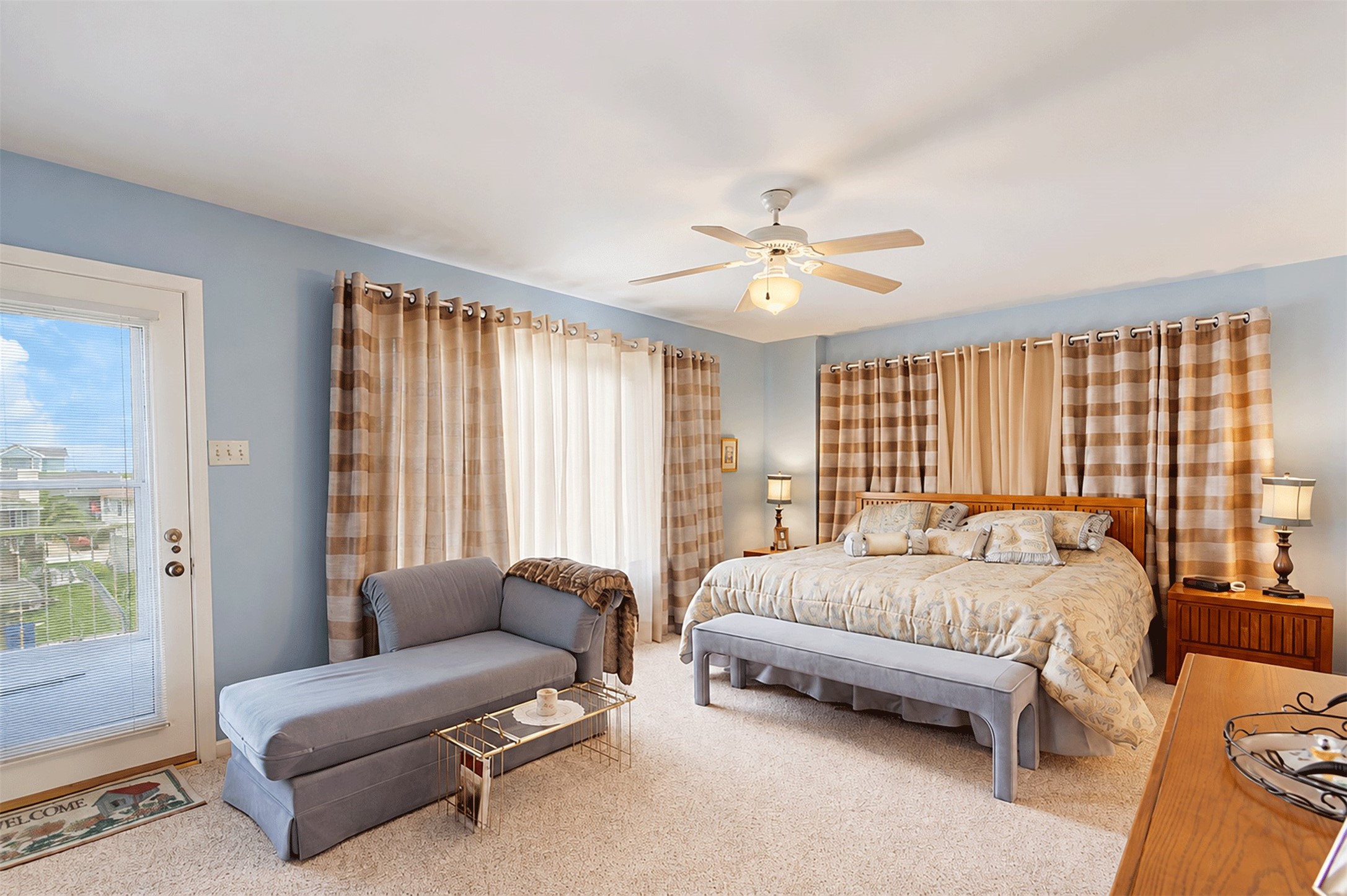 Primary bedroom with direct access to the deck and canal views.