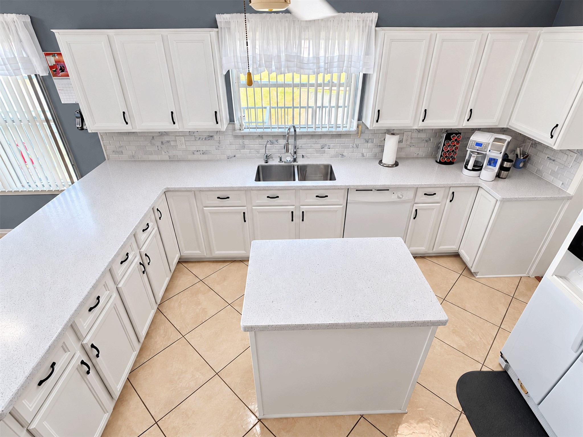 Upgraded kitchen with new cabinet doors, soft-close drawers, and a large center island.