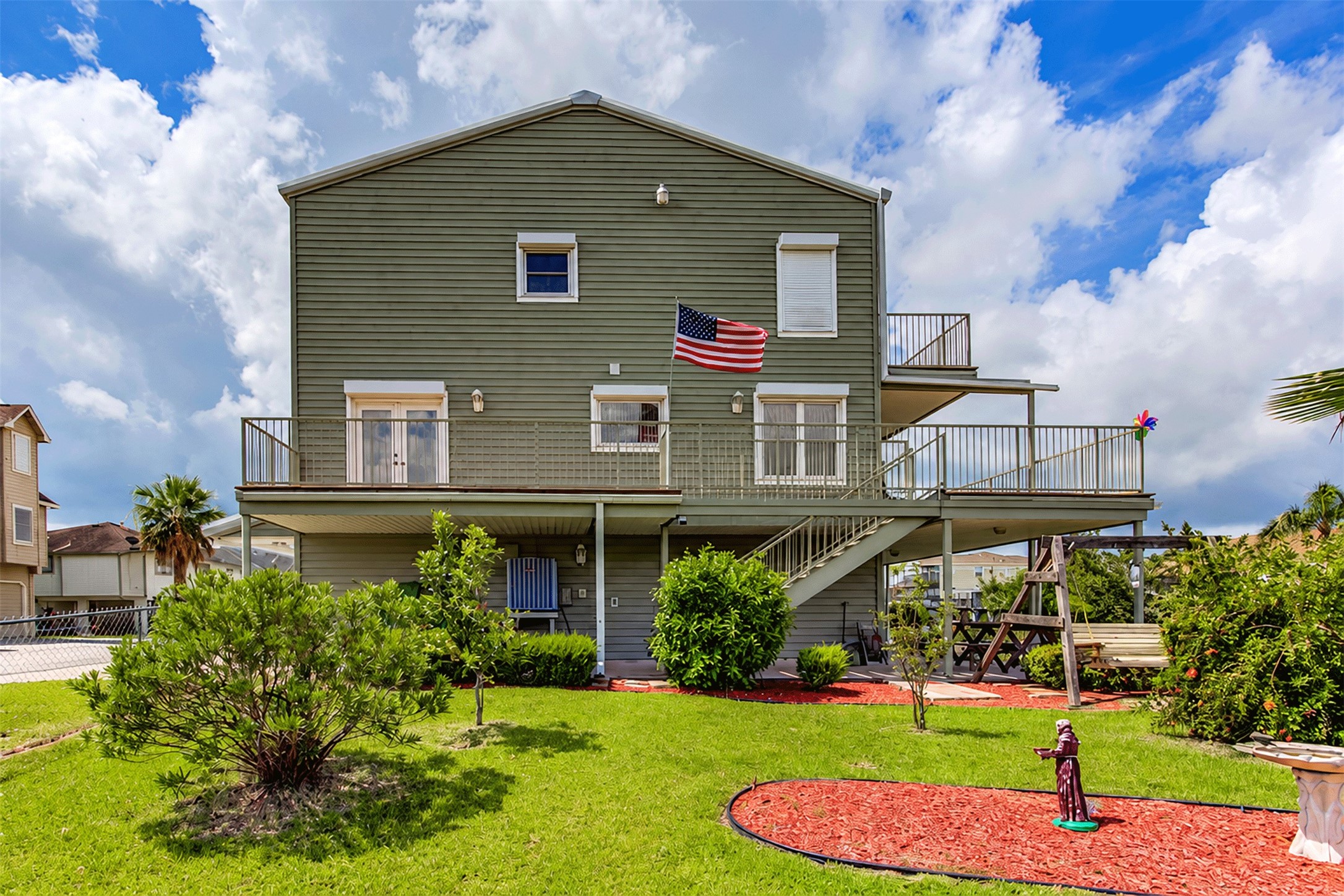 Waterside view of the home showing the wraparound decks on every level, perfect for enjoying the breeze. Waterside view of the home showing the wraparound decks on every level, perfect for enjoying the breeze.