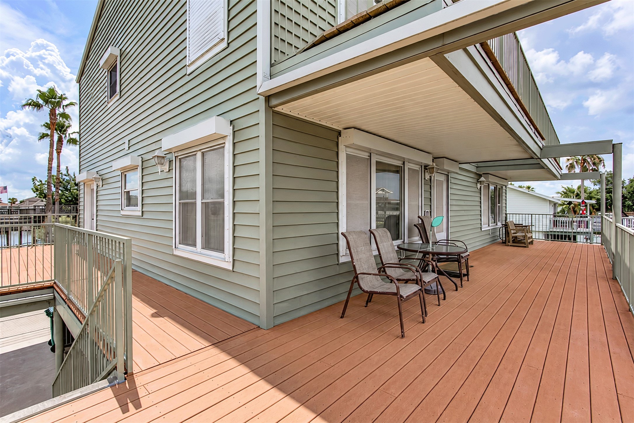 Large Trex deck wrapping the home, low-maintenance and built for coastal living.