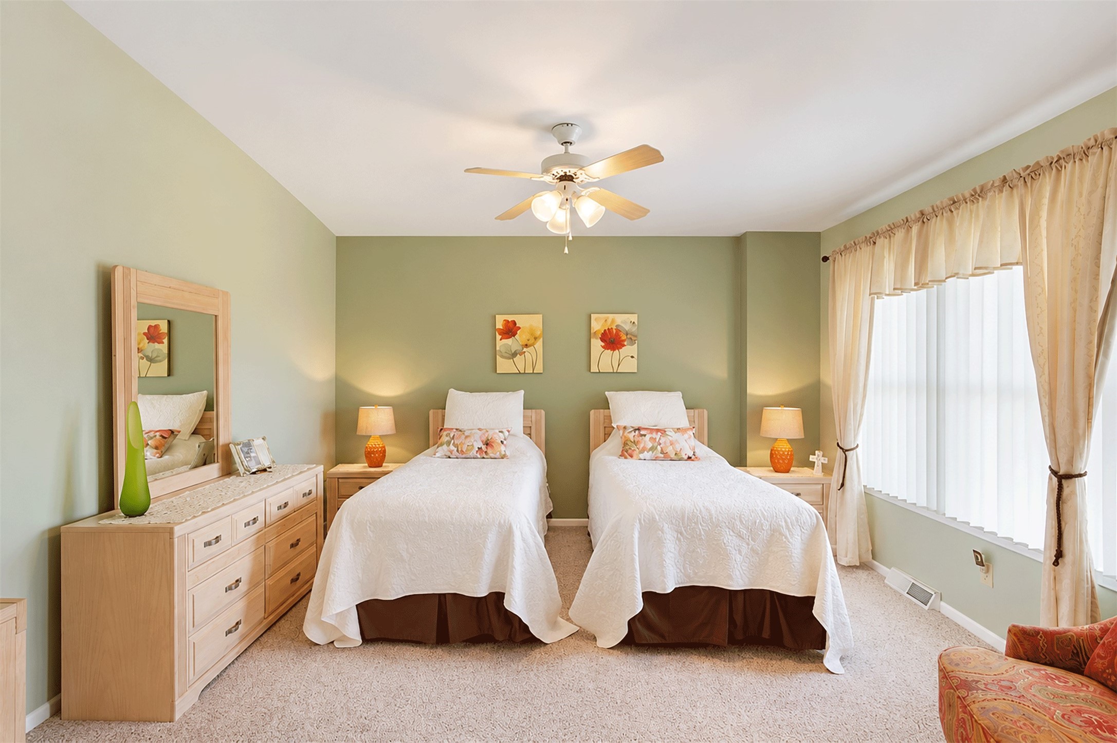 Upstairs bedroom with soft neutral tones and a ceiling fan.