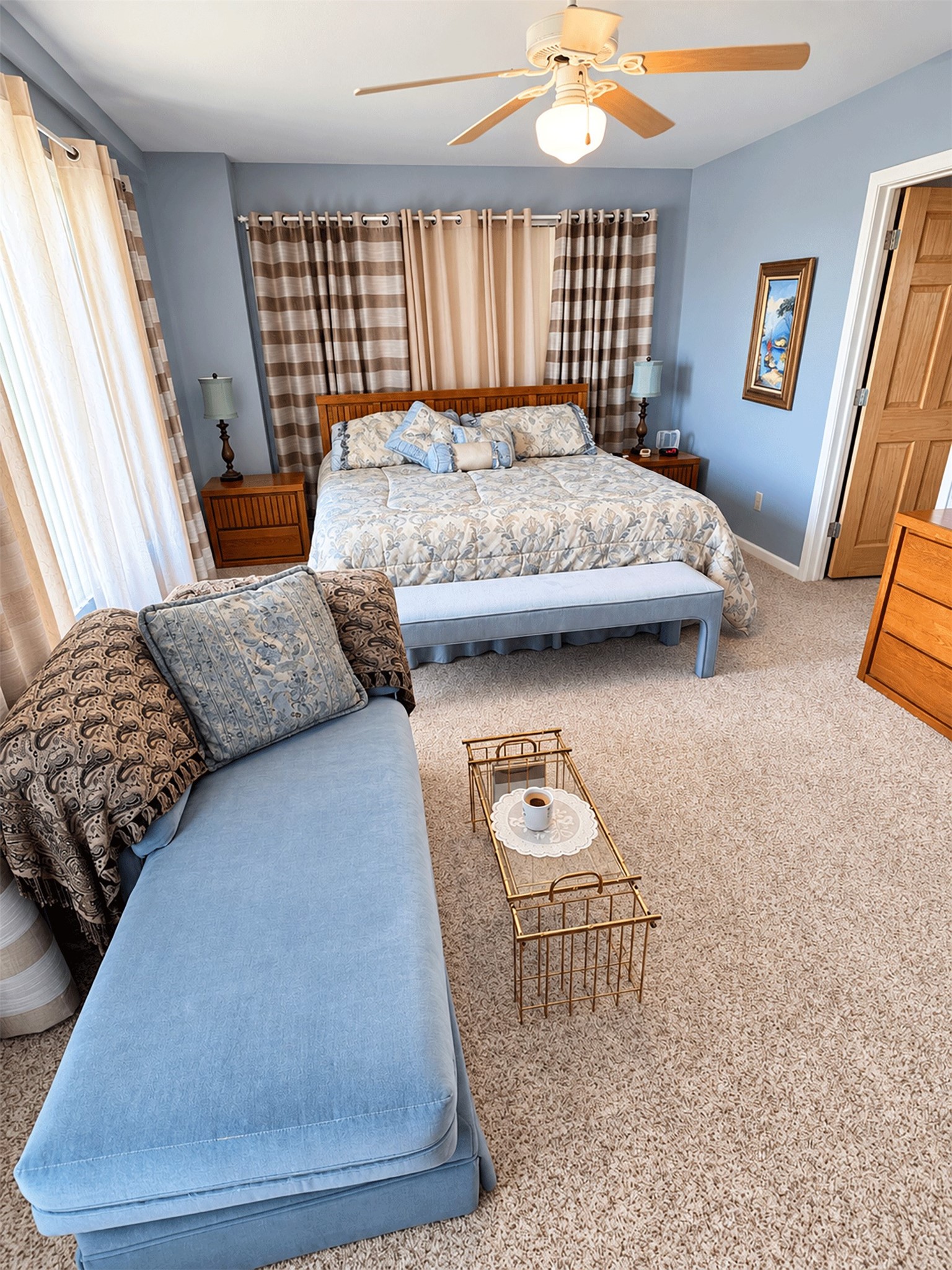 Another view of the primary bedroom showing its size and natural light.
