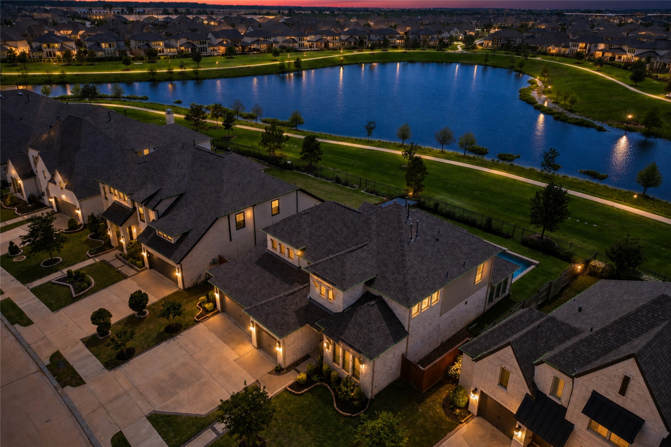 A scenic lake with a walking path enhances the tranquil setting with a resort-style pool.