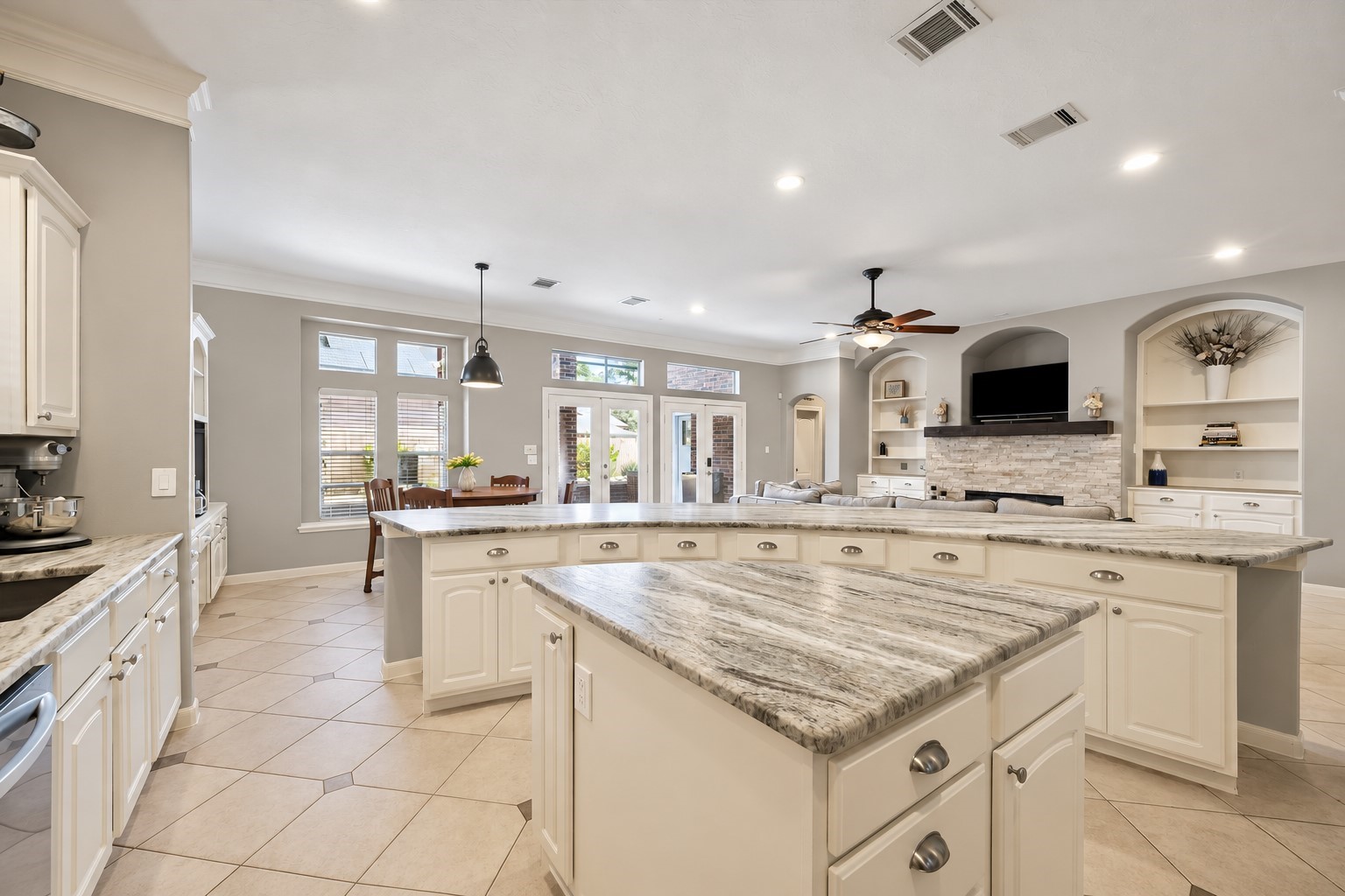 Remodeled kitchen with honed granite counter and impressive curved island