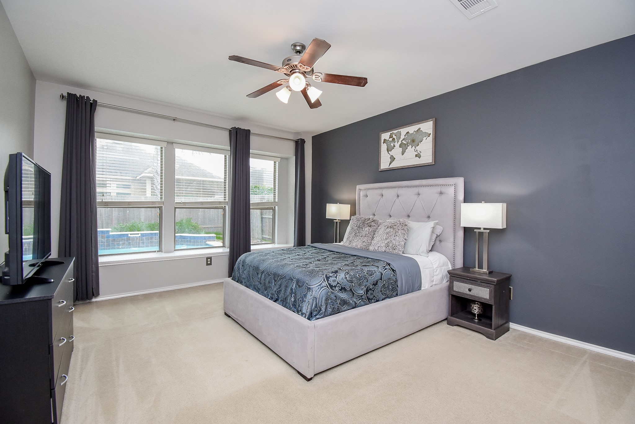 Owner's retreat with a wall of windows offering great views of the swimming pool!