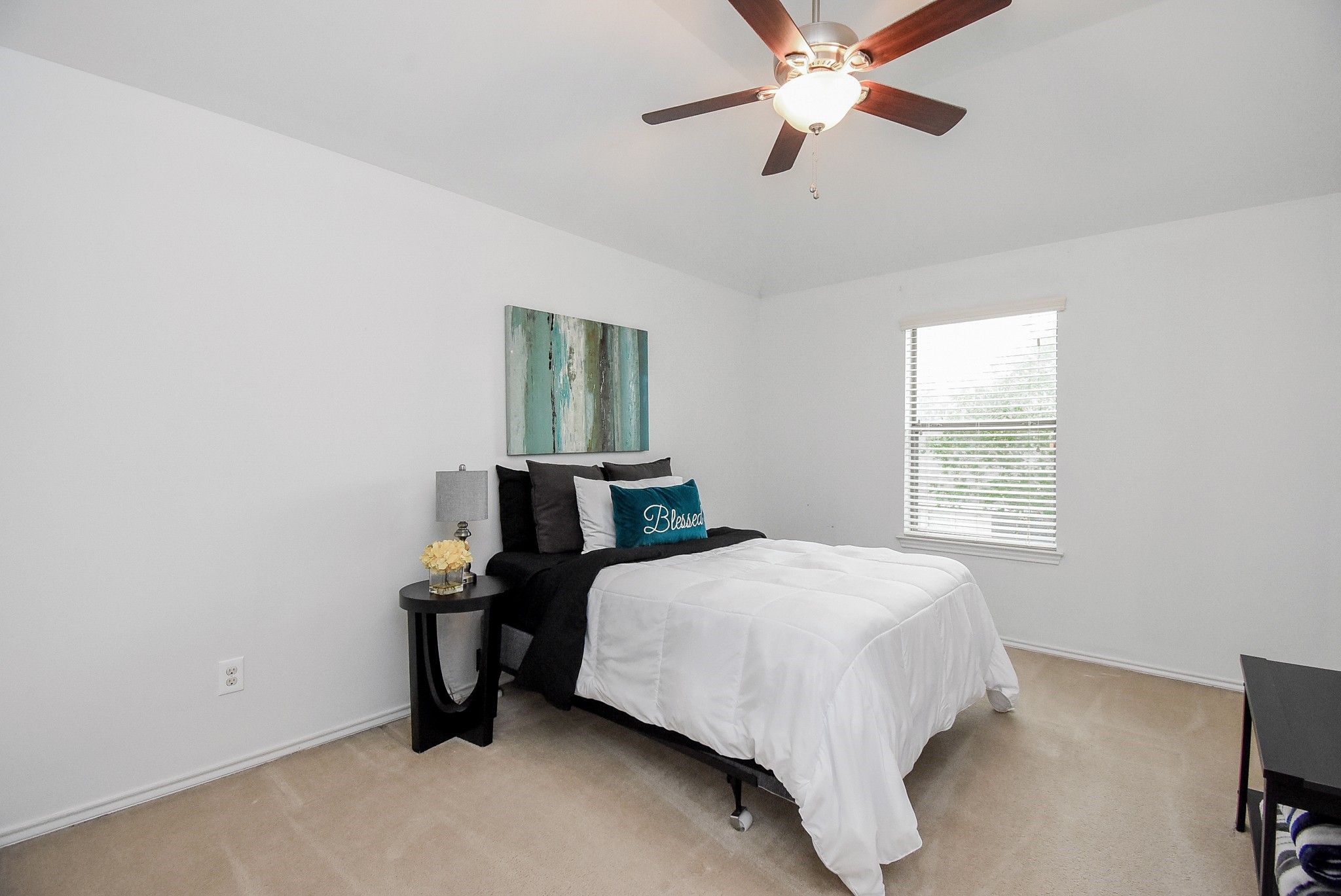 Bedroom 3 also has a view of the pool and a ceiling fan!