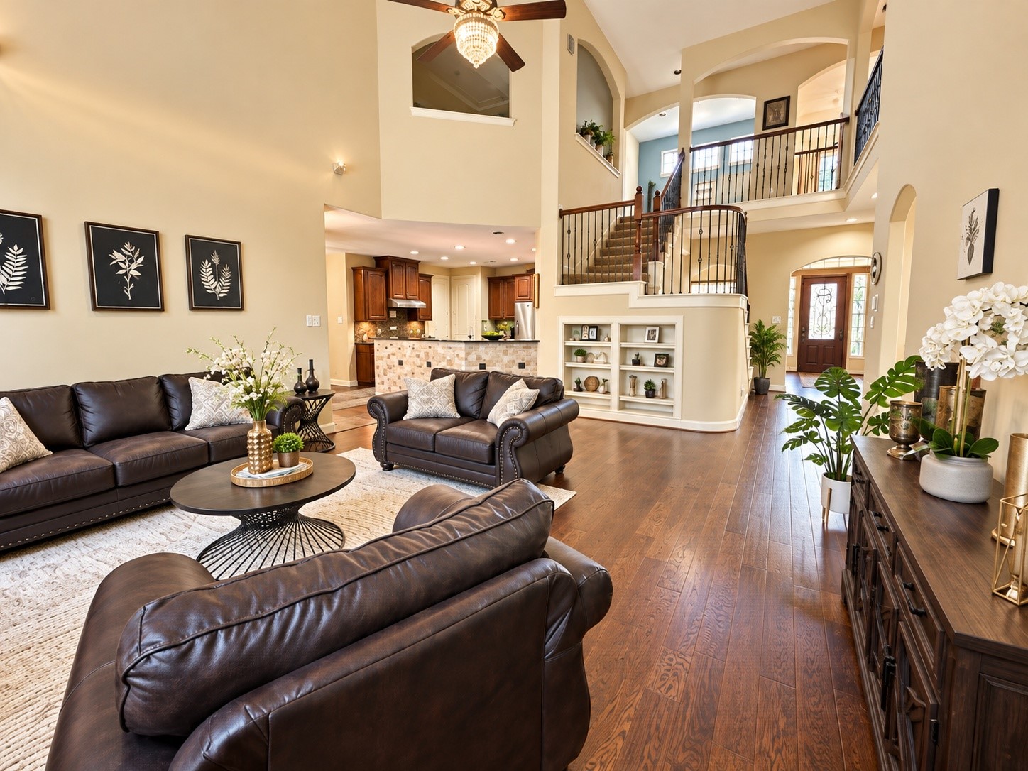 Beautifully designed living area featuring elegant archways, rich wood flooring, and an airy, welcoming atmosphere.