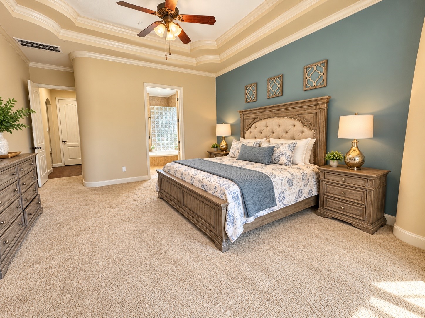Inviting primary suite with multiple windows overlooking the backyard and mature landscaping.